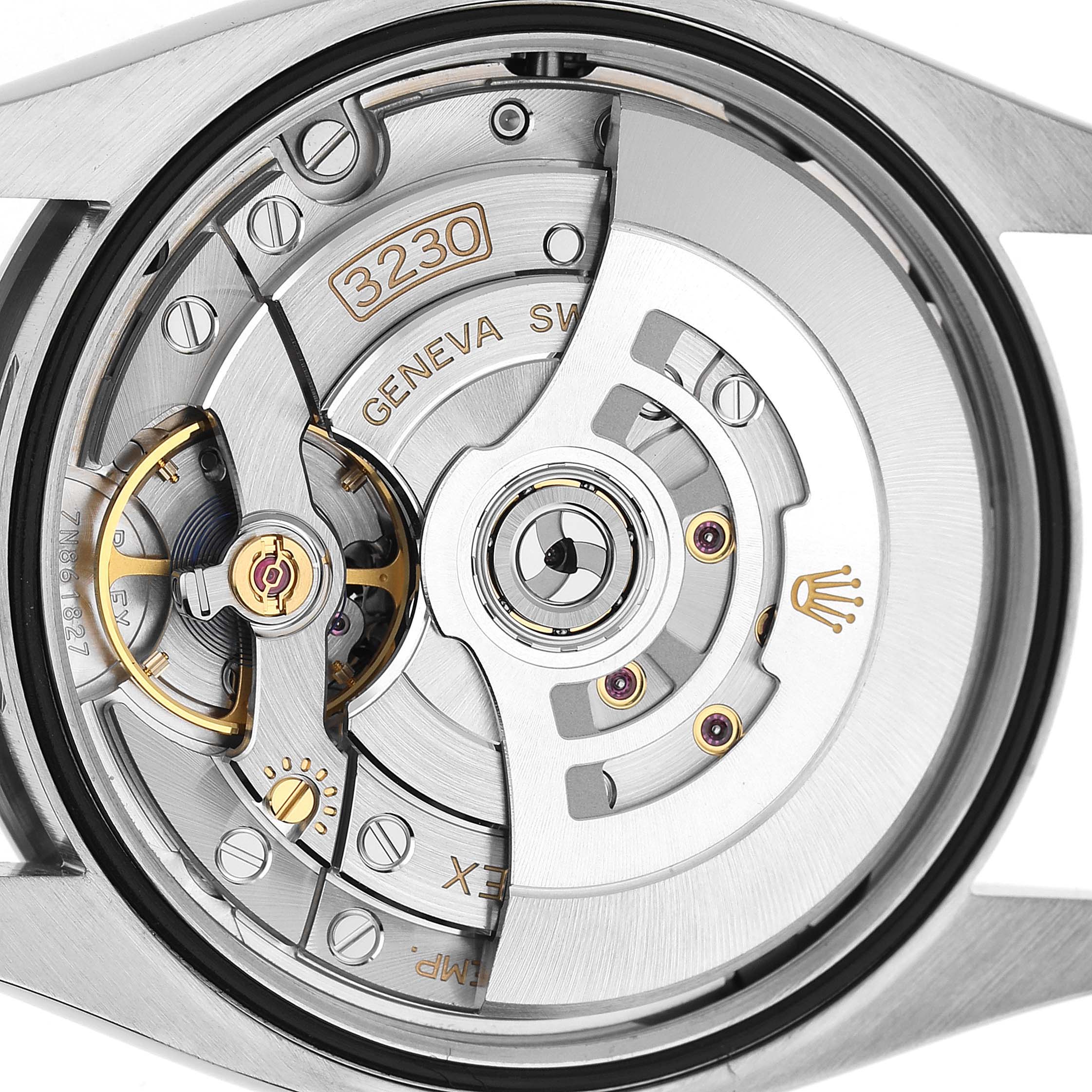 The image shows the back view of a Rolex Oyster Perpetual 126000 Men's Stainless Steel Black Dial watch, highlighting the intricate movement mechanism.