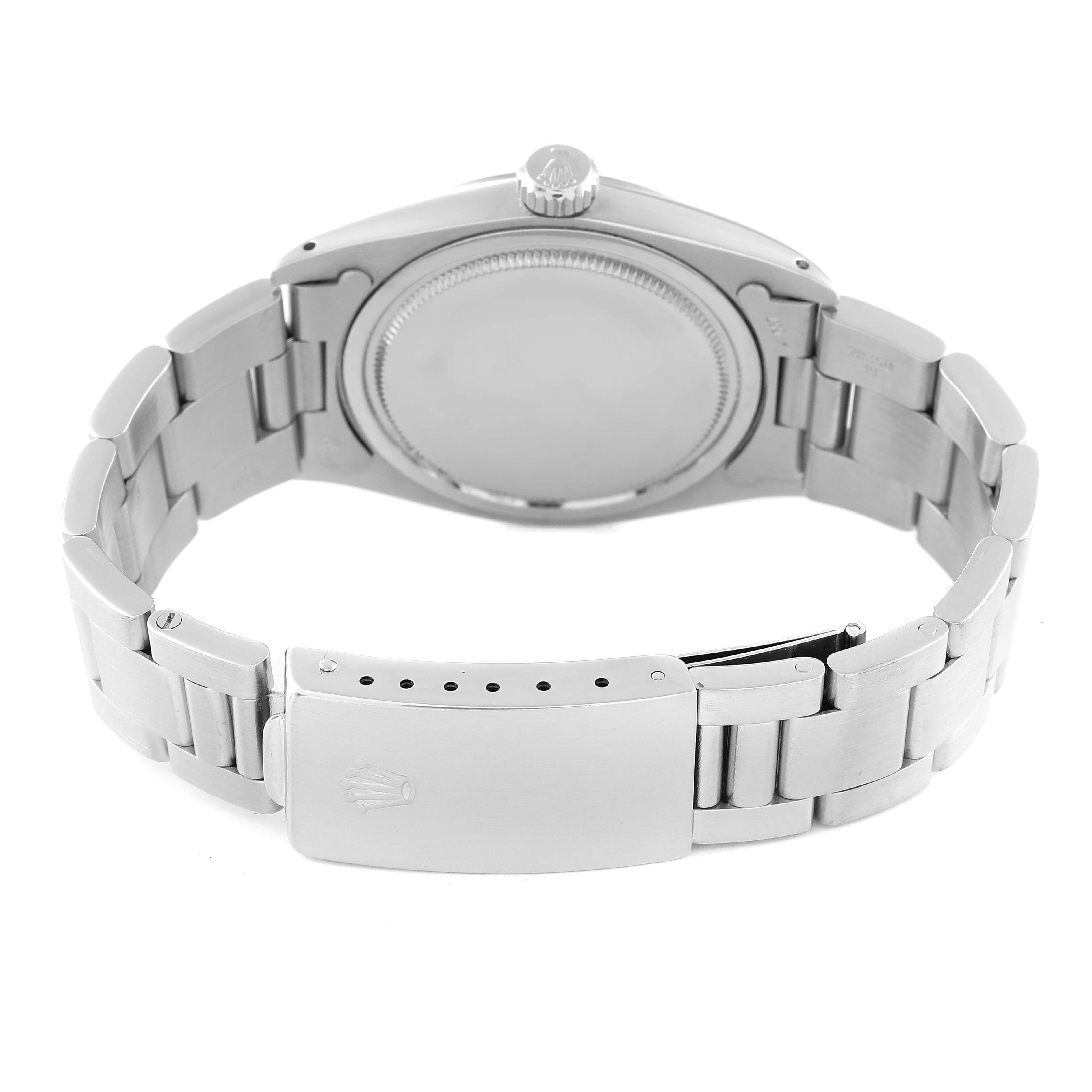 The image shows the back view of a Vintage Collection Rolex watch, focusing on the case back and stainless steel bracelet with a clasp.