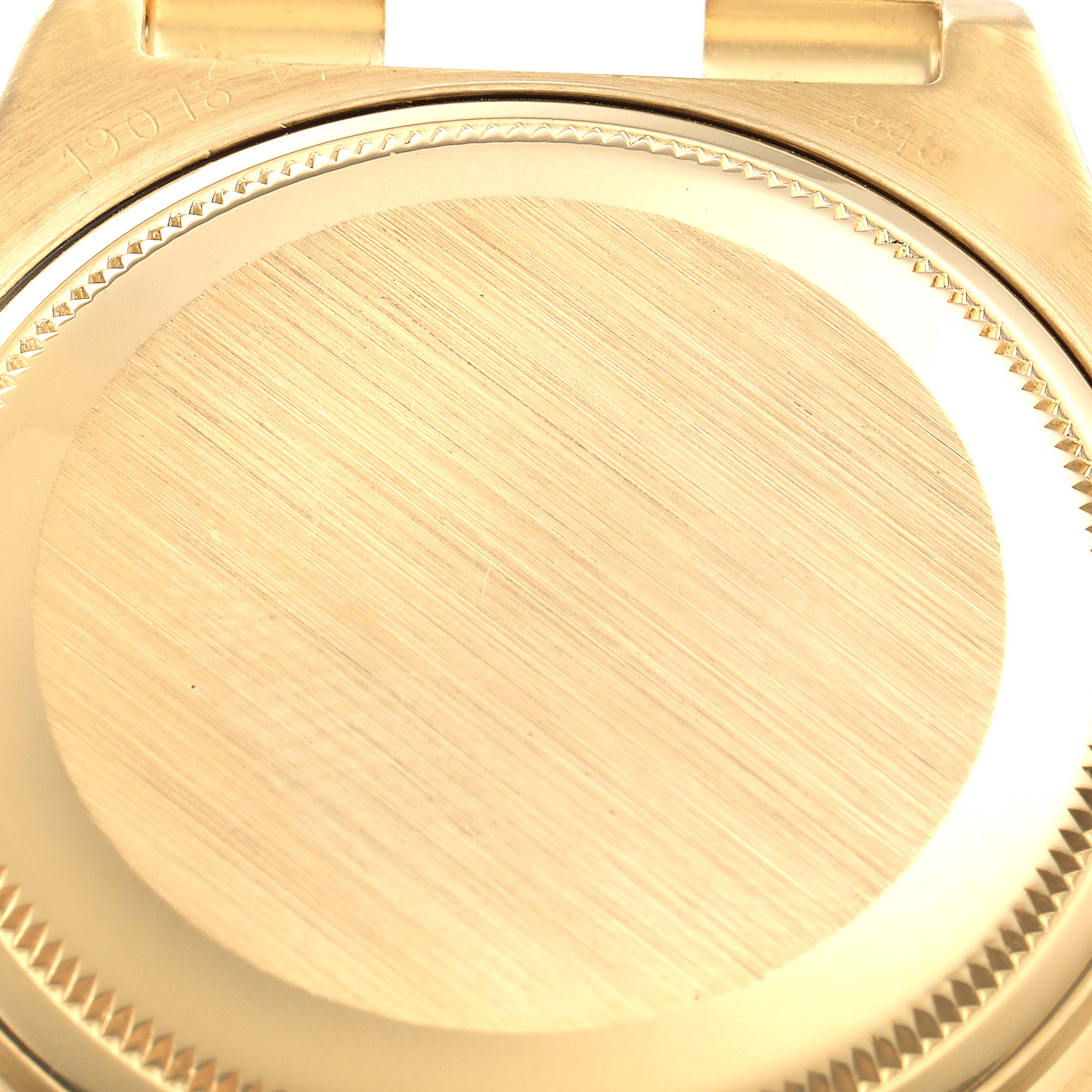 This image shows the case back of a Rolex Oysterquartz 19018 Men's Yellow Gold Champagne Dial 19018 Men's Yellow Gold Champagne Dial watch at a close-up angle.