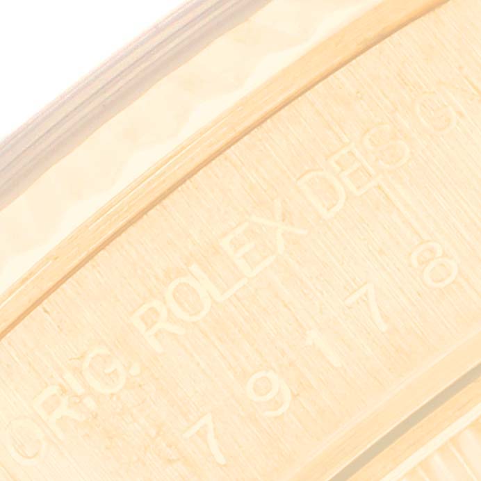 This image shows a close-up of the engraved inner case back of a Rolex President 79178 Women's Yellow Gold Blue Dial 79178 Women's Yellow Gold Blue Dial model watch.
