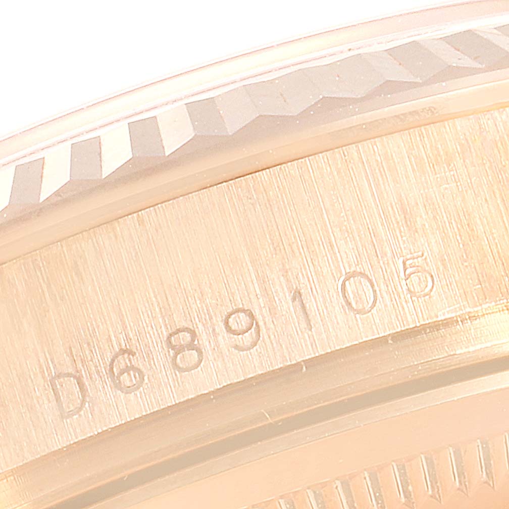 This image shows a close-up of the engraved serial number on the Rolex President 118235 Men's Rose Gold Pink Dial 118235 Men's Rose Gold Pink Dial model watch case.