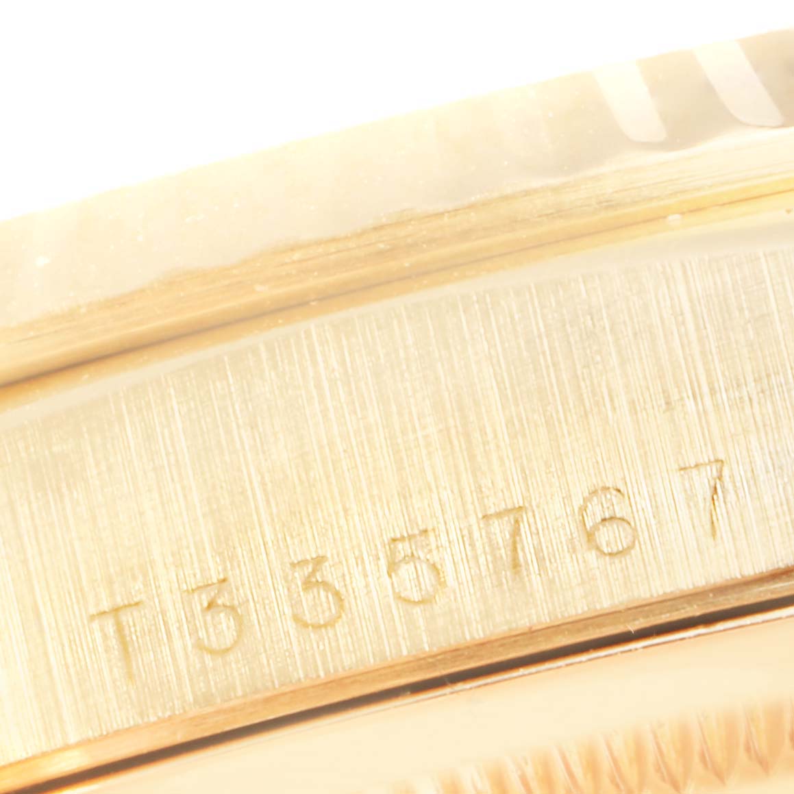 This close-up image shows the serial number engraving on the case of a Rolex President 18238 Men
s Yellow Gold White Dial 18238 Men
s Yellow Gold White Dial model watch.
