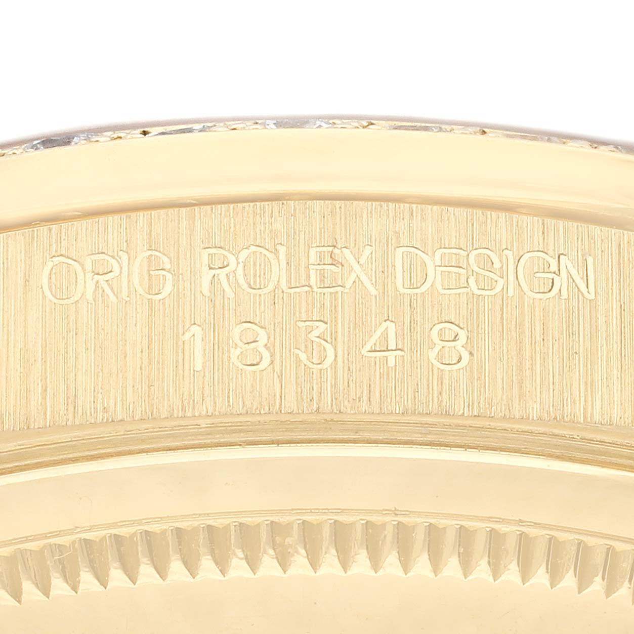 The image shows a close-up angle of the Rolex President 18348 Men
s Yellow Gold Champagne Dial 18348 Men
s Yellow Gold Champagne Dial model focusing on the engraved case-side with "ORIG ROLEX DESIGN" and the model number.