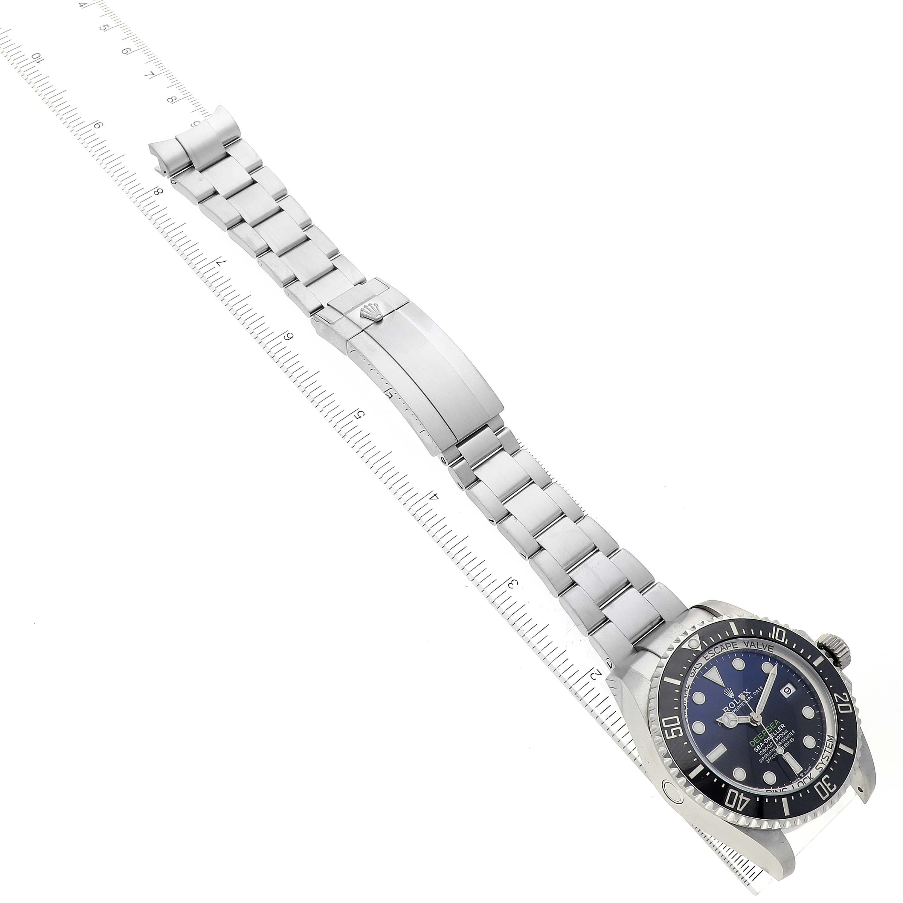 The Rolex Sea-Dweller 136660 Men
s Stainless Steel Blue Dial 136660 Men
s Stainless Steel Blue Dial watch is shown at an angle highlighting the face, bezel, and bracelet with the clasp extended.