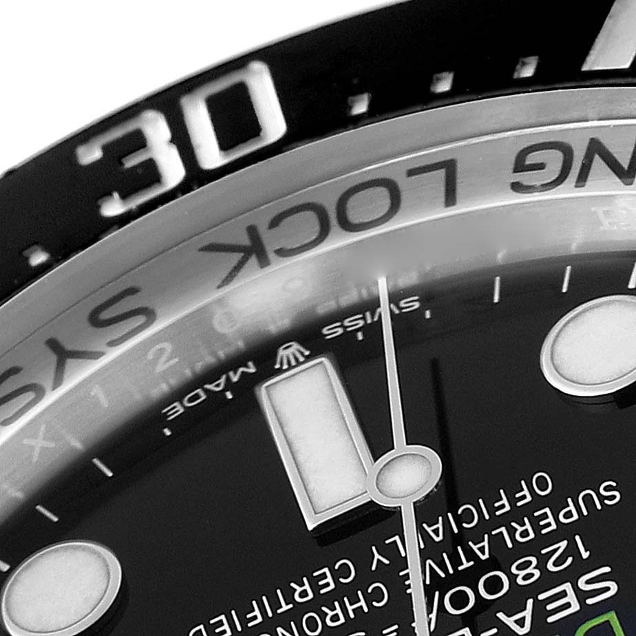 The image shows a close-up angle of the dial and bezel of a Rolex Sea-Dweller 136660 Men
s Stainless Steel Blue Dial 136660 Men
s Stainless Steel Blue Dial watch, highlighting markings and part of the hands.