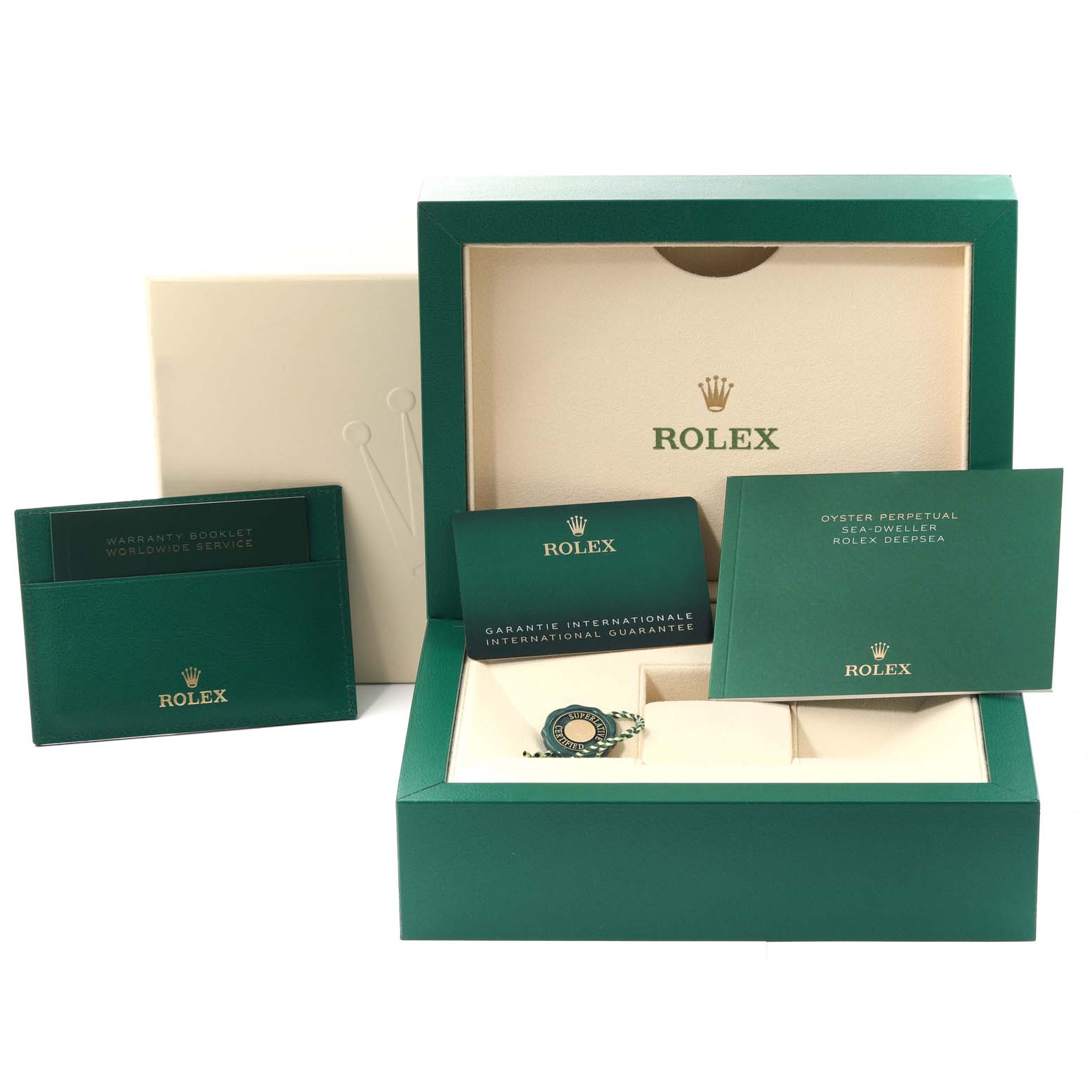 The image shows the open box of a Rolex Sea-Dweller 136660 Men
s Stainless Steel Blue Dial 136660 Men
s Stainless Steel Blue Dial watch along with its warranty booklet, international guarantee card, and tag.