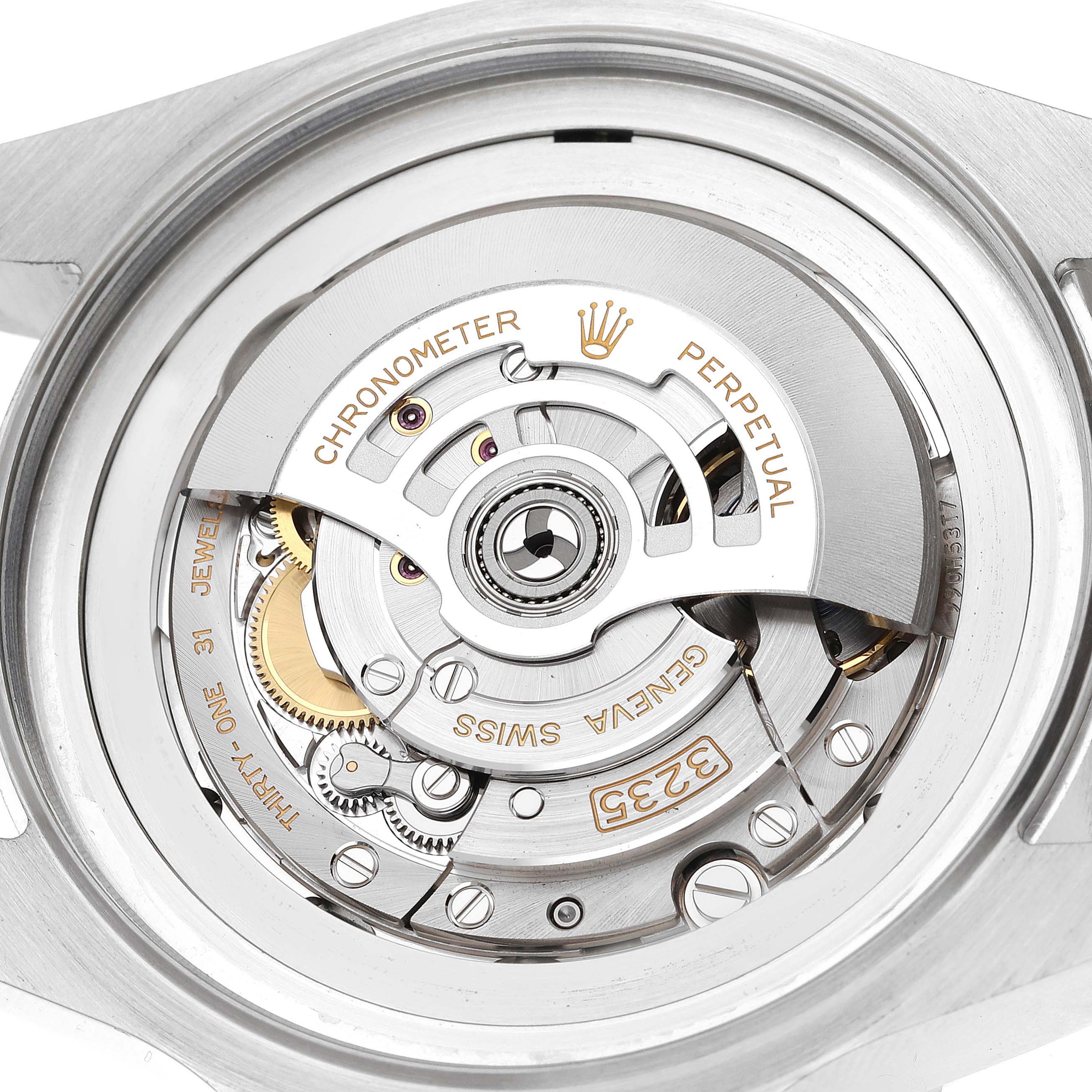 The image shows an angled close-up of the Rolex Sea-Dweller 136660 Men
s Stainless Steel Blue Dial 136660 Men
s Stainless Steel Blue Dial
s movement, highlighting its intricate mechanical parts and inscriptions.