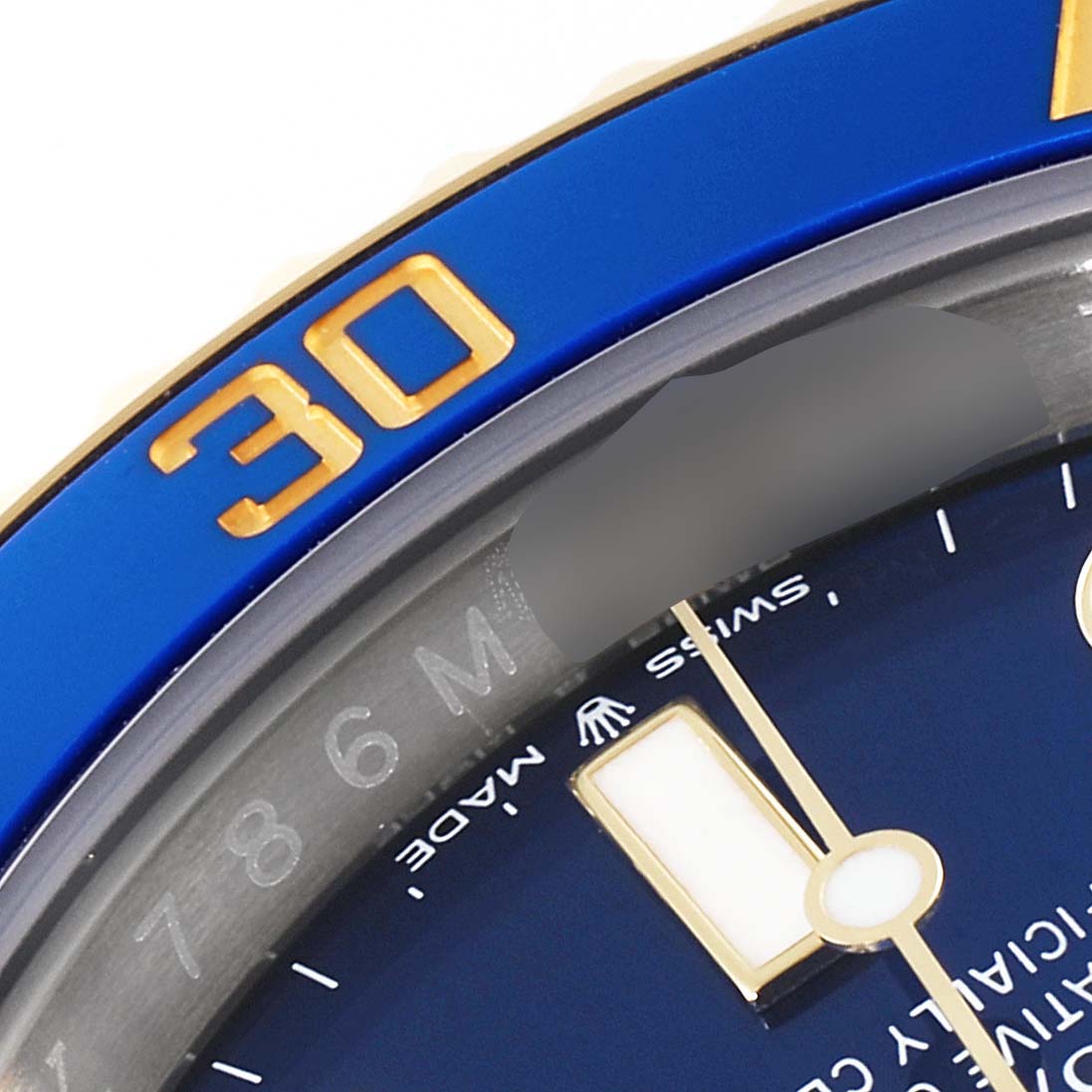 The close-up angle shows part of the dial and bezel of a Rolex Submariner 126613 Men's Steel and Gold (two tone) Blue Dial 126613 Men's Steel and Gold (two tone) Blue Dial watch, featuring the "30" marker and "SWISS MADE" text.