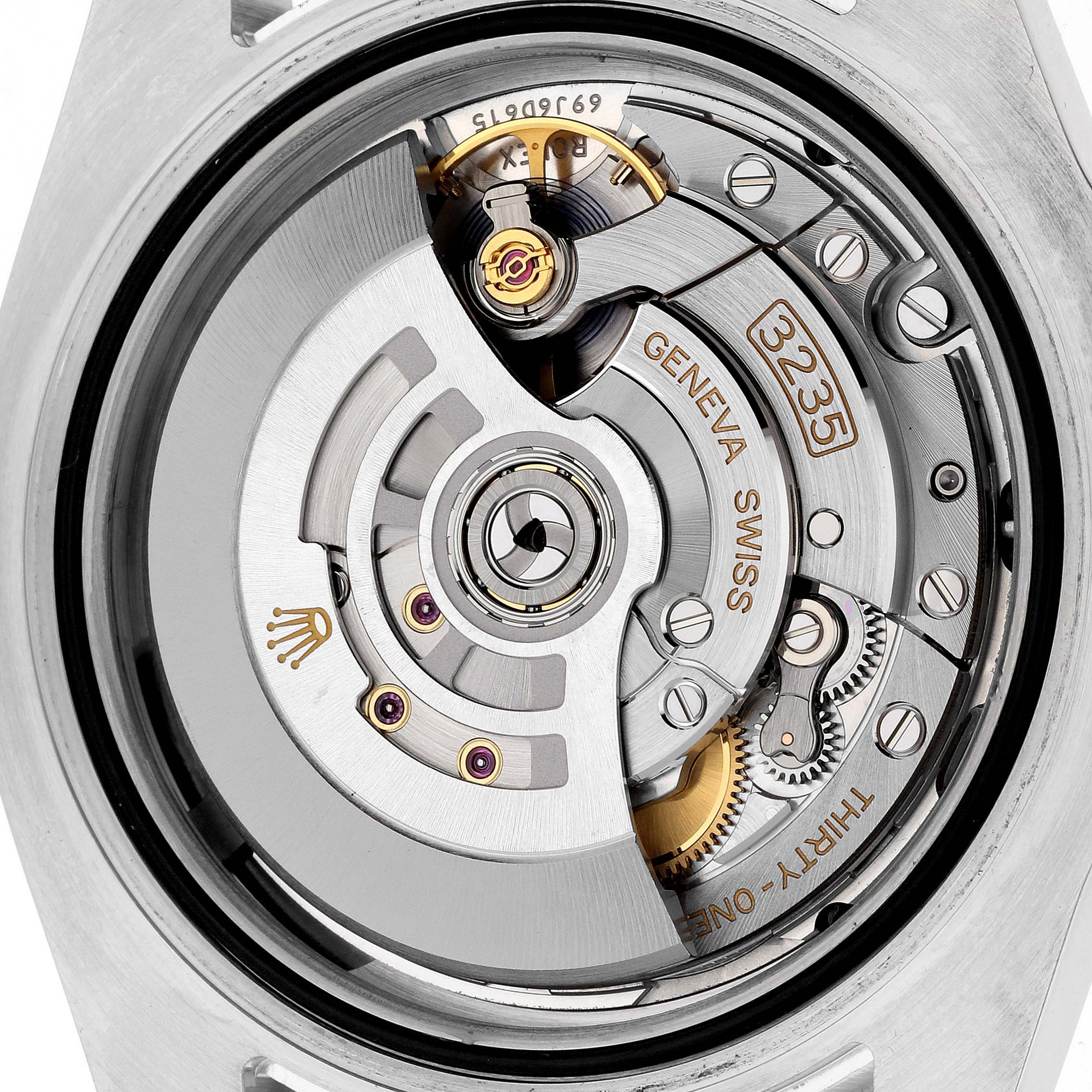 The image shows a close-up of the movement mechanism of a Rolex Submariner 126610LN Men's Stainless Steel Black Dial 126610LN Men's Stainless Steel Black Dial watch, highlighting the intricate gears and components.