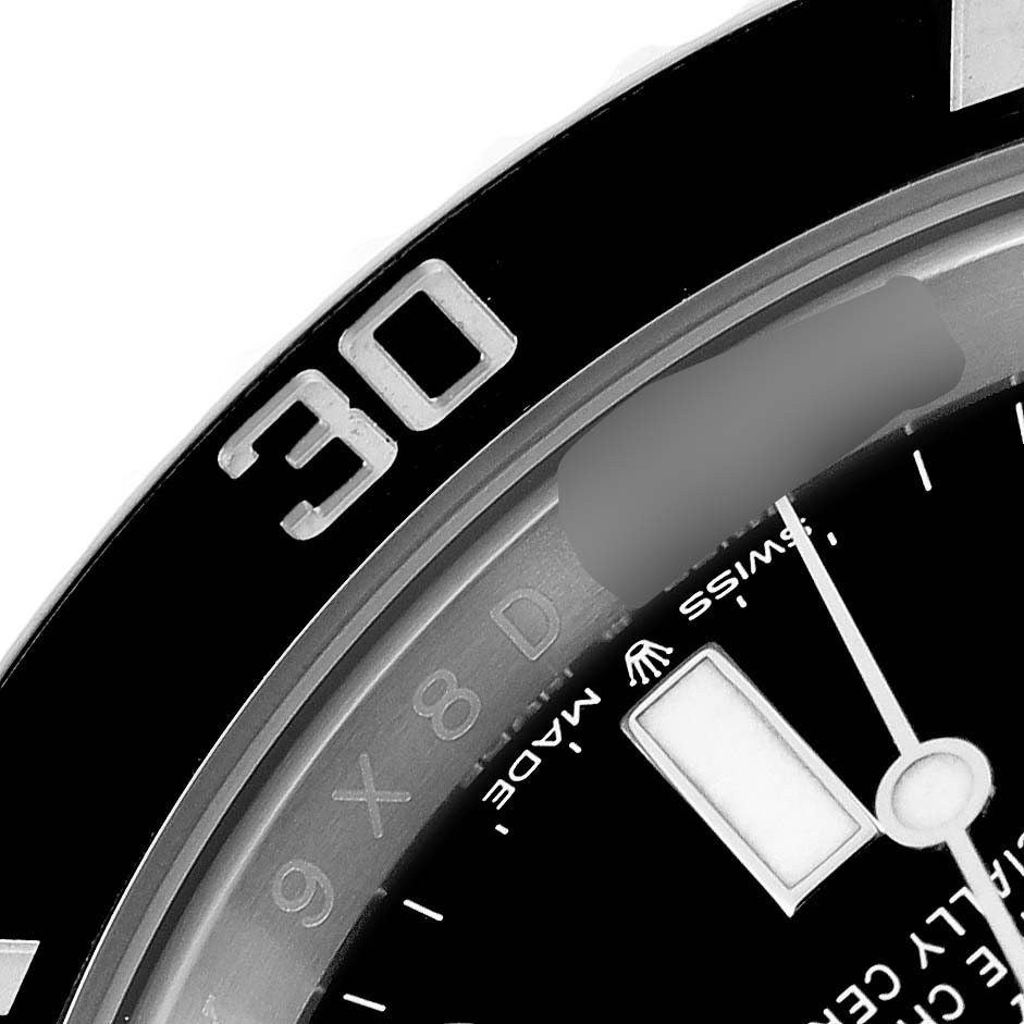 This close-up image of the Rolex Submariner 126610LN Men
s Stainless Steel Black Dial 126610LN Men
s Stainless Steel Black Dial watch shows part of the bezel, dial, and minute hand.