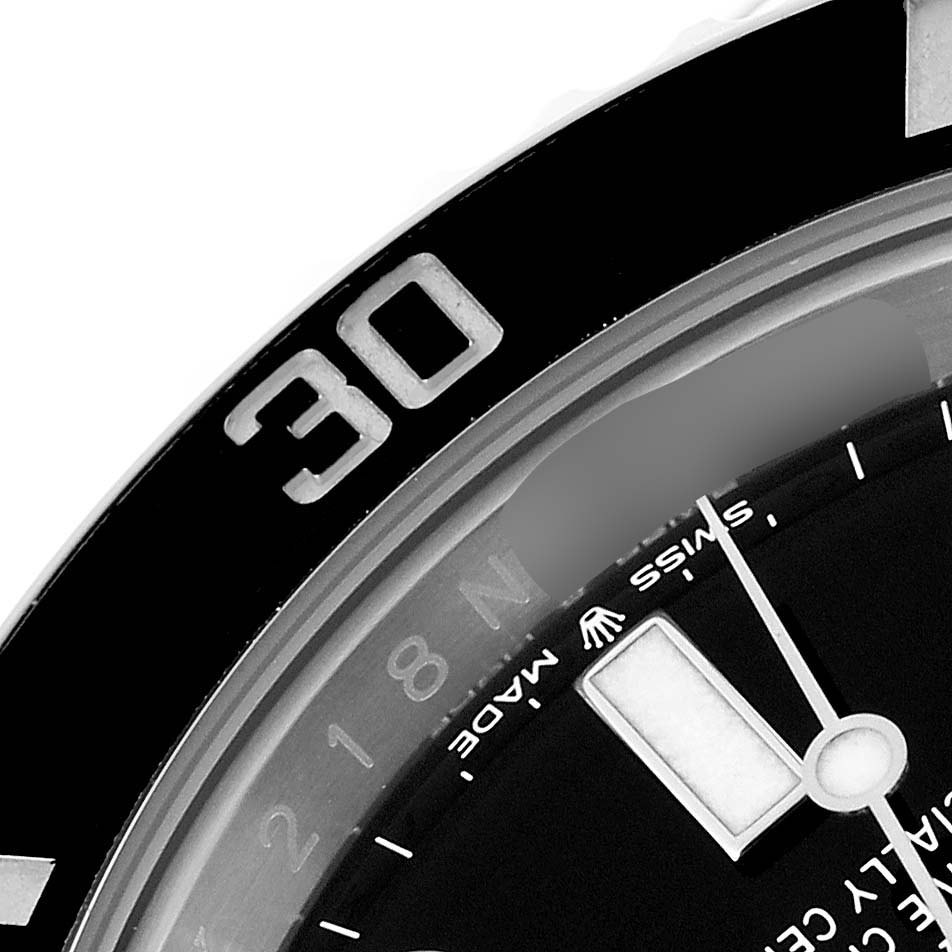 This close-up shows a partial view of the bezel and dial of the Rolex Submariner 126610LN Men
s Stainless Steel Black Dial 126610LN Men
s Stainless Steel Black Dial watch, including the "30" minute marker and some text.