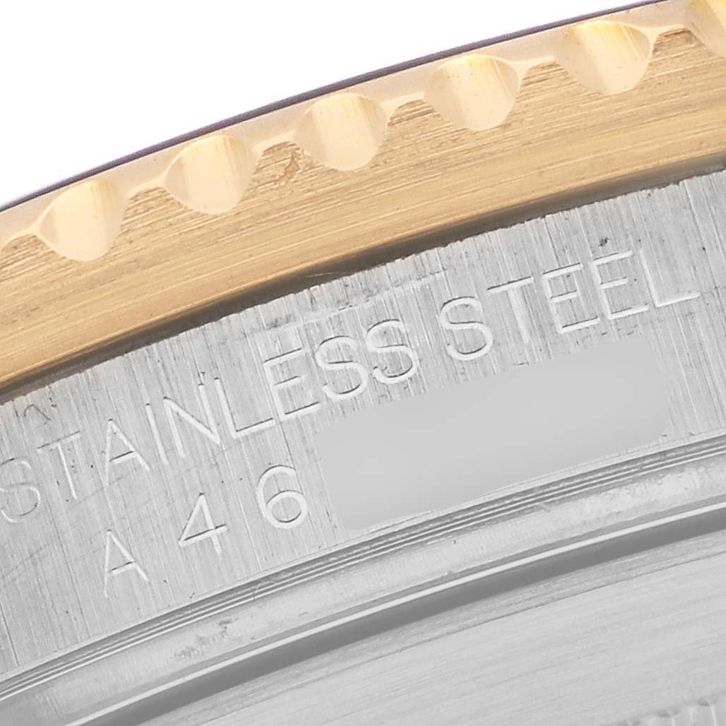 This image shows a close-up of the edge of the bezel and the engraved case back of a Rolex Submariner 16613 Men's Steel and Gold (two tone) Blue Dial 16613 Men's Steel and Gold (two tone) Blue Dial watch.