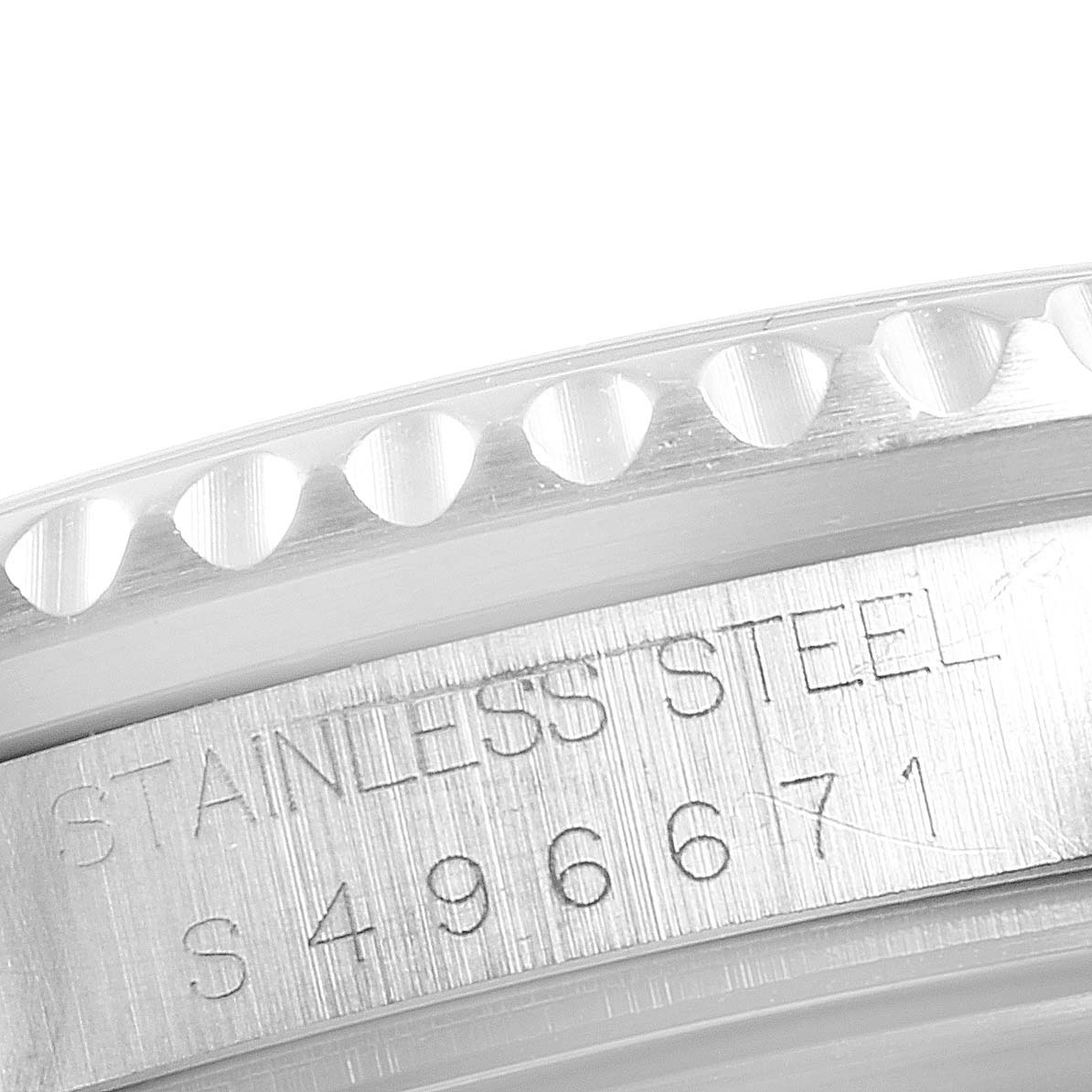 This image shows a close-up angle of the bezel and outer edge of the case back of a Rolex Submariner 16610 Men
s Stainless Steel Black Dial 16610 Men
s Stainless Steel Black Dial watch, highlighting the stainless steel engraving and serial number.