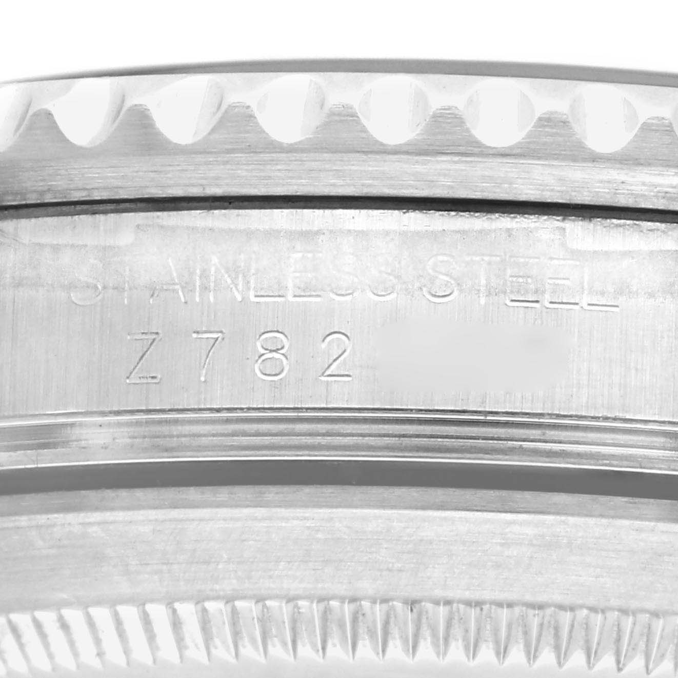 This image shows the side profile of the bezel and part of the case back of a Rolex Submariner 16610 Men
s Stainless Steel Black Dial 16610 Men
s Stainless Steel Black Dial, highlighting the stainless steel engraving.