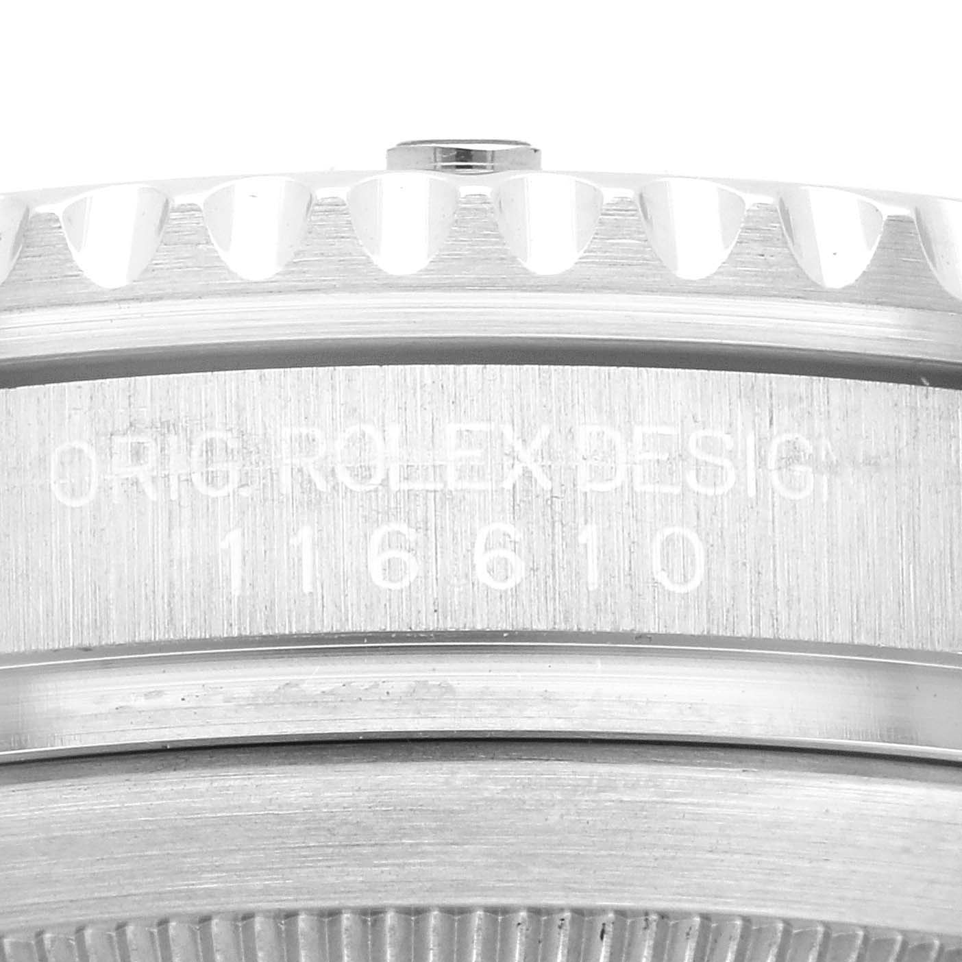 The image shows an extreme close-up of the engraved serial/model number and part of the bezel of a Rolex Submariner 116610LV Men
s Stainless Steel Green Dial 116610LV Men
s Stainless Steel Green Dial watch.
