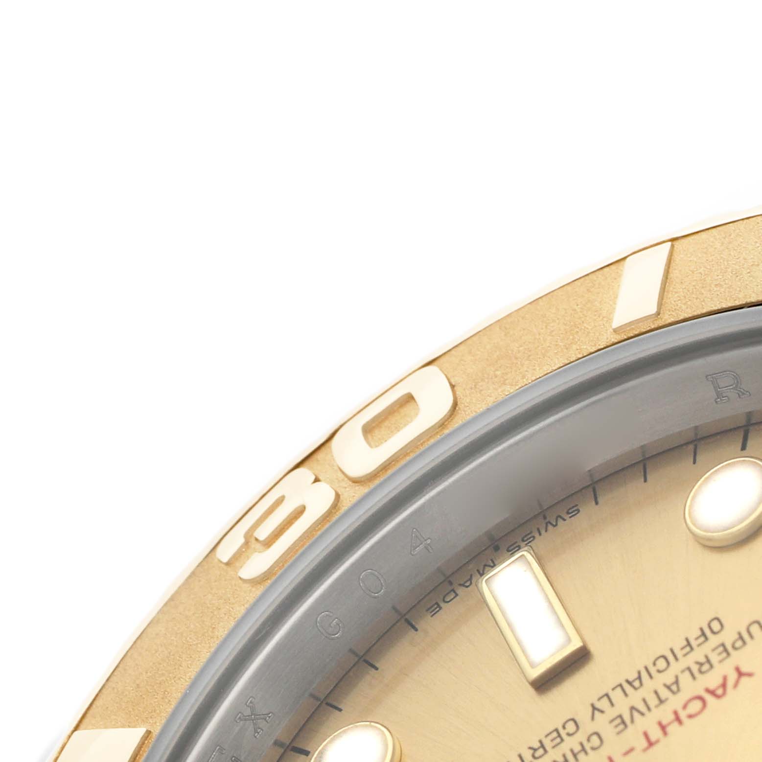 The image shows a close-up of the bezel and part of the dial of a Rolex Yacht-Master 16623 Men's Steel and Gold (two tone) Champagne Dial watch, emphasizing the 30-minute marker.