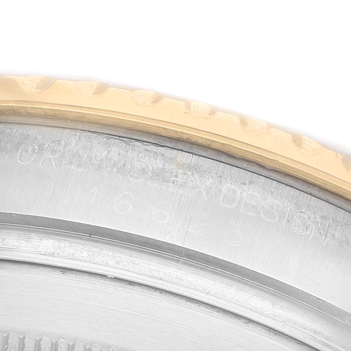 The image shows a close-up of the bezel and engraved text on the side of the Rolex Yacht-Master 16623 Men's Steel and Gold (two tone) Champagne Dial watch case.