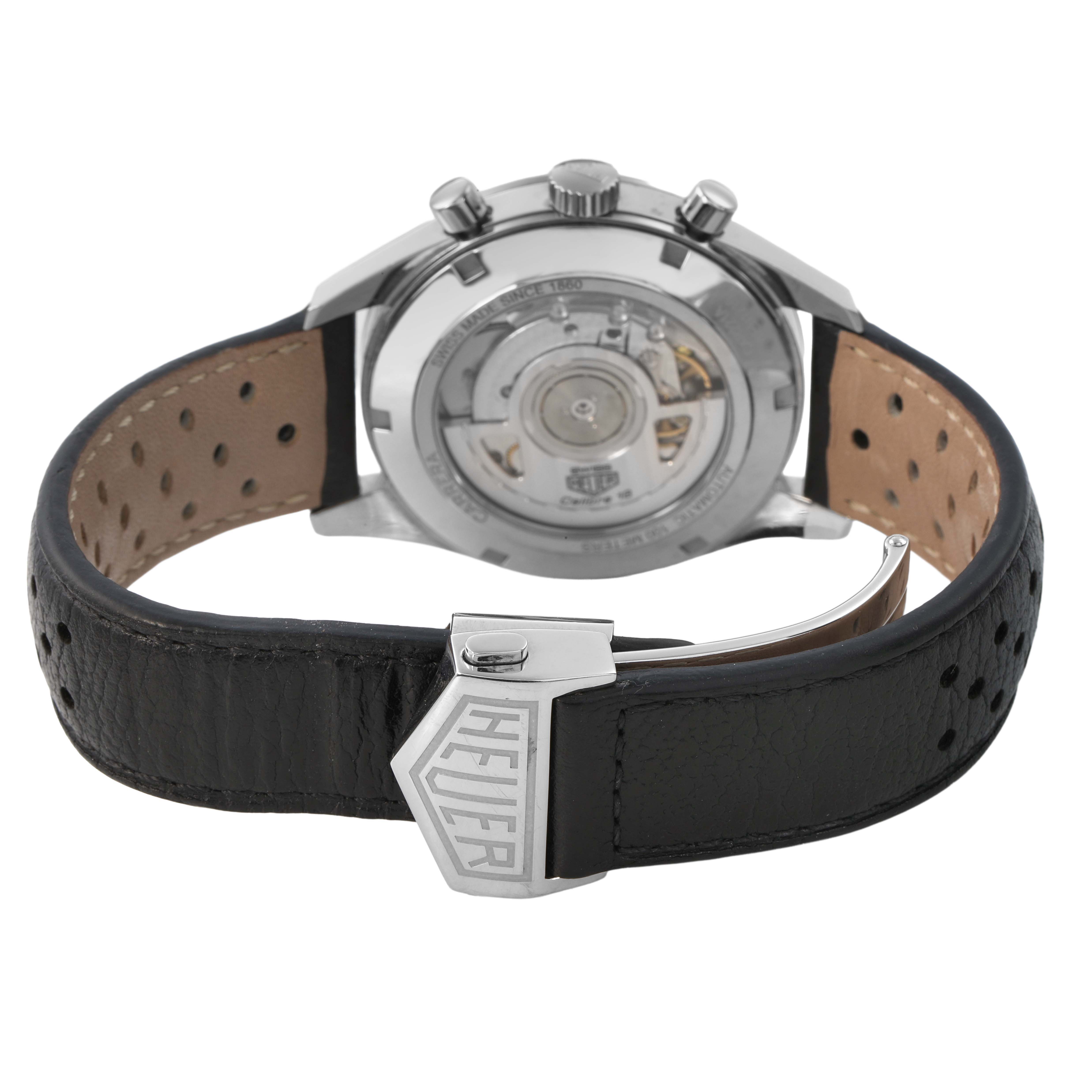 The image shows the back of a Tag Heuer Carrera CAR221A Men's Stainless Steel Silver Dial watch, highlighting its transparent case back and black leather strap with buckle.