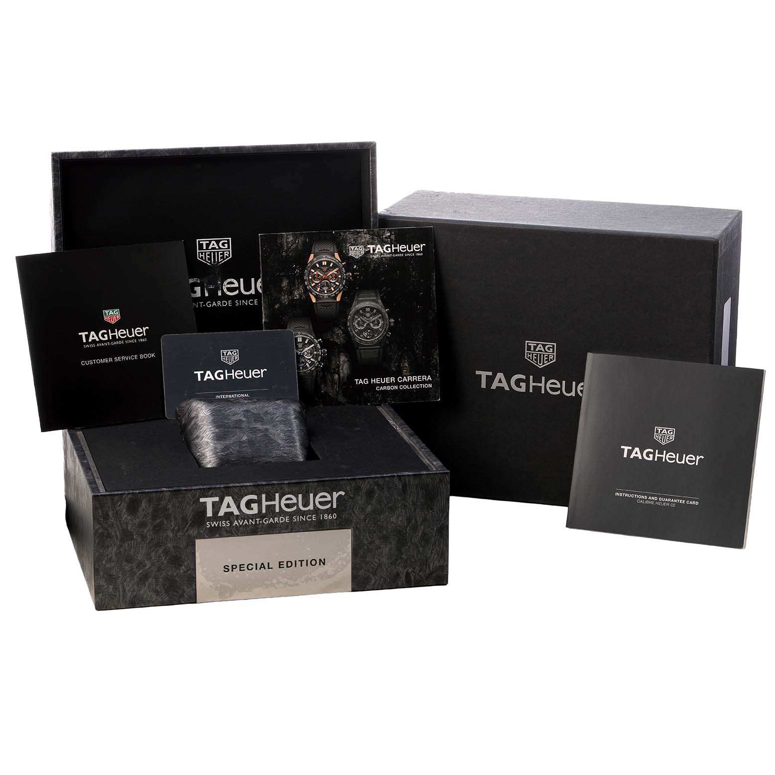 The image shows the Tag Heuer Carrera CBG2017 Men's Stainless Steel Black Dial watch box and accessories, including manuals and warranty cards, from a front angle.