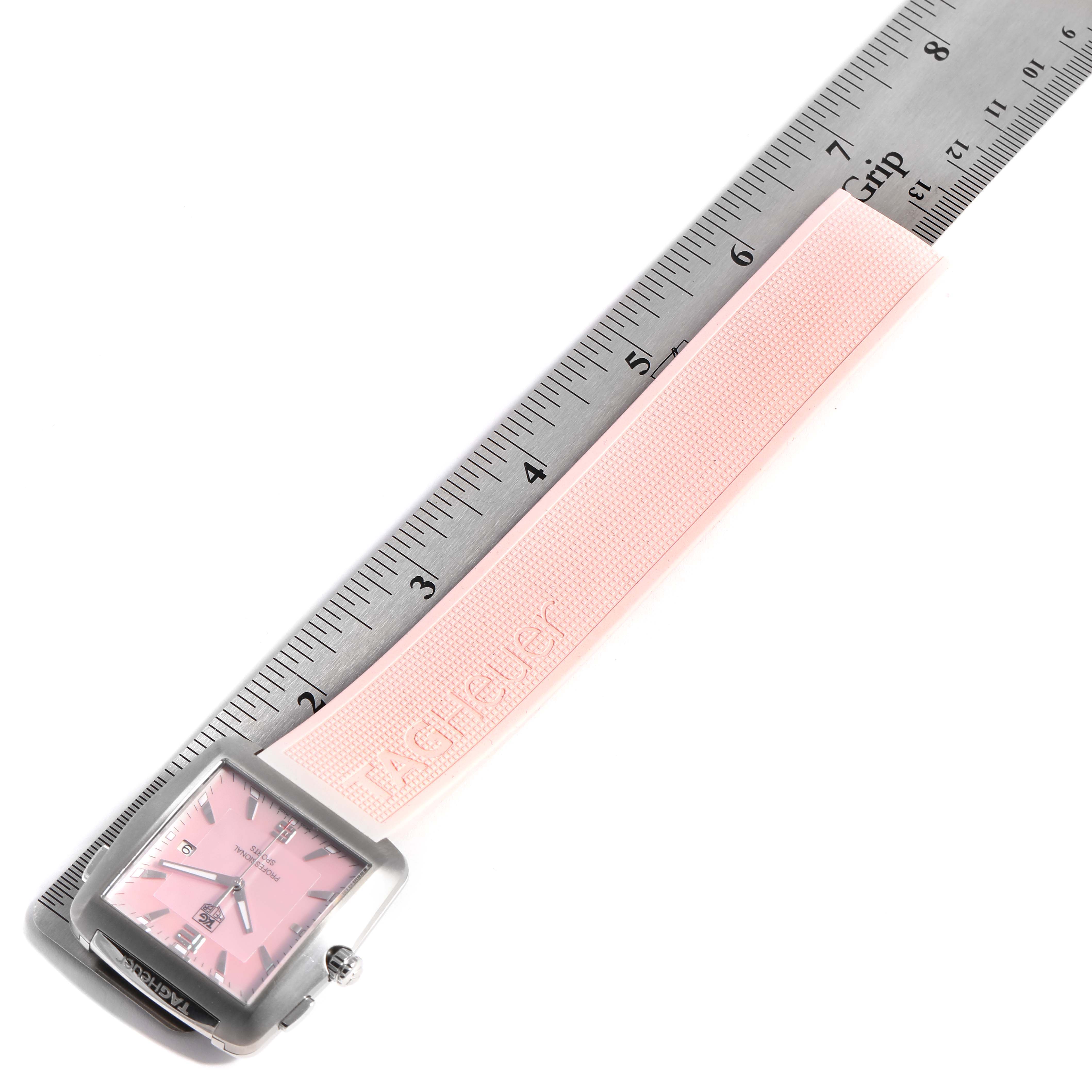 The image shows a Tag Heuer Monaco WAE1114.FT6011 Women's Stainless Steel Mother of Pearl Dial WAE1114.FT6011 Women's Stainless Steel Mother of Pearl Dial watch with a pink strap placed next to a ruler for measurement.