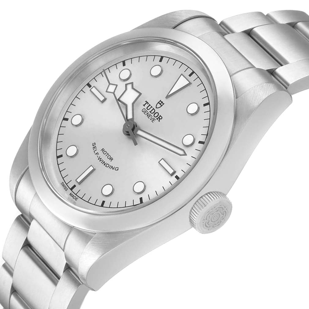 The Tudor Heritage Black Bay M79540 Men's Stainless Steel Silver Dial watch is shown at an angled view, highlighting the dial, bezel, bracelet, and crown.