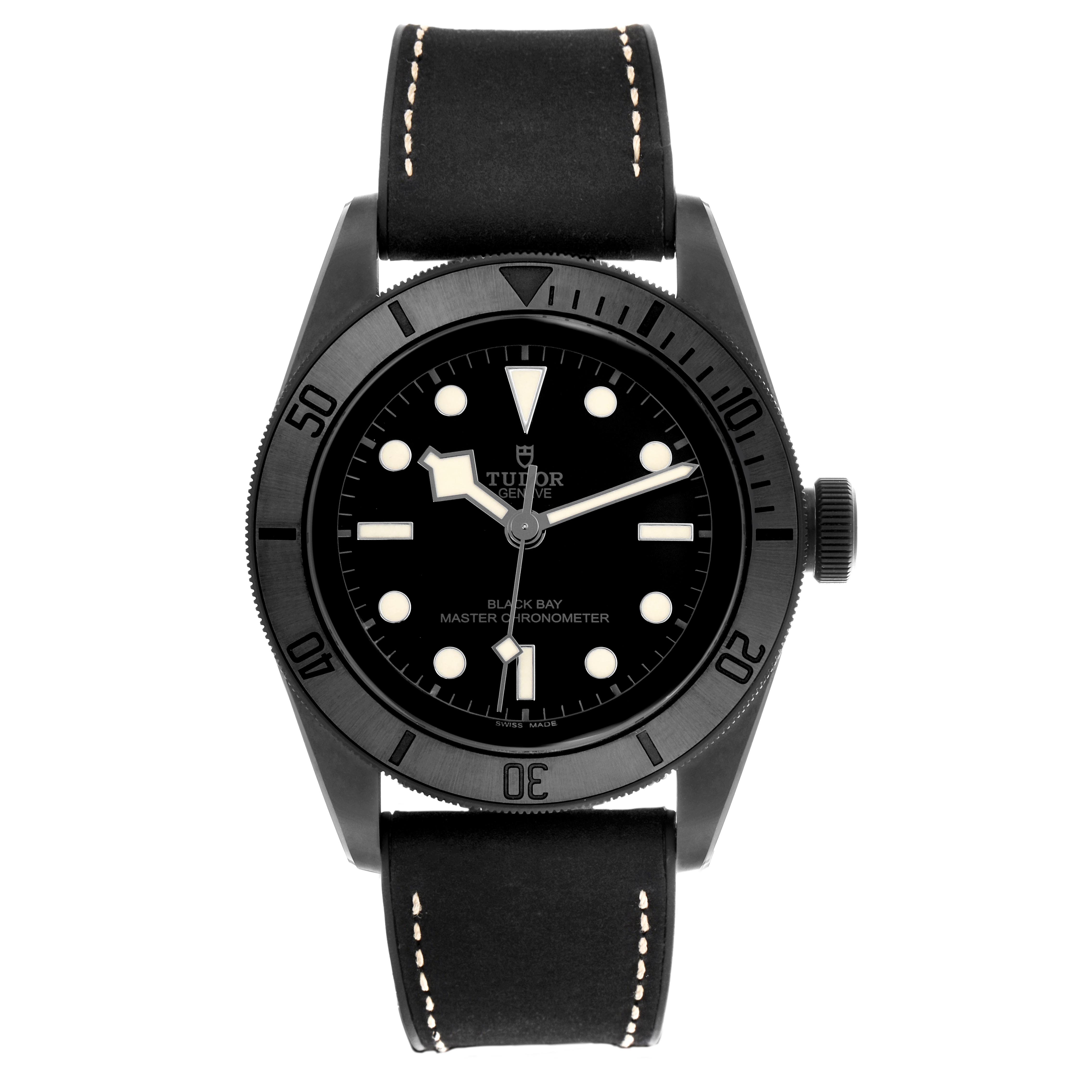 The Tudor Heritage Black Bay 79210 Men's Ceramic Black Dial 79210 Men's Ceramic Black Dial watch is shown from a top-down angle, highlighting its black dial, bezel, and leather strap.