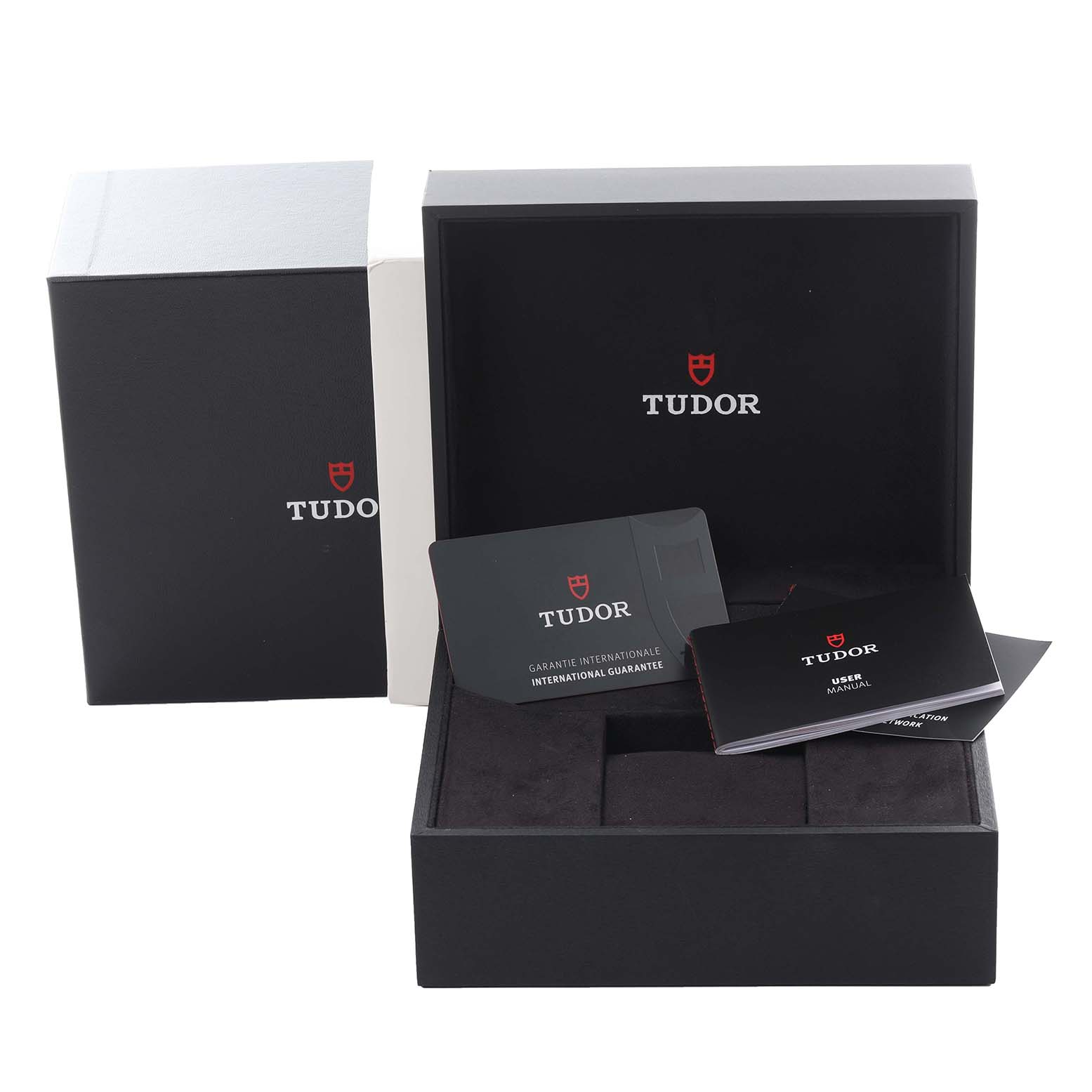 The image shows the packaging and accessories for the Tudor Heritage Black Bay 79210CNU Men's Ceramic Black Dial 79210CNU Men's Ceramic Black Dial, including the box, manuals, and warranty card.