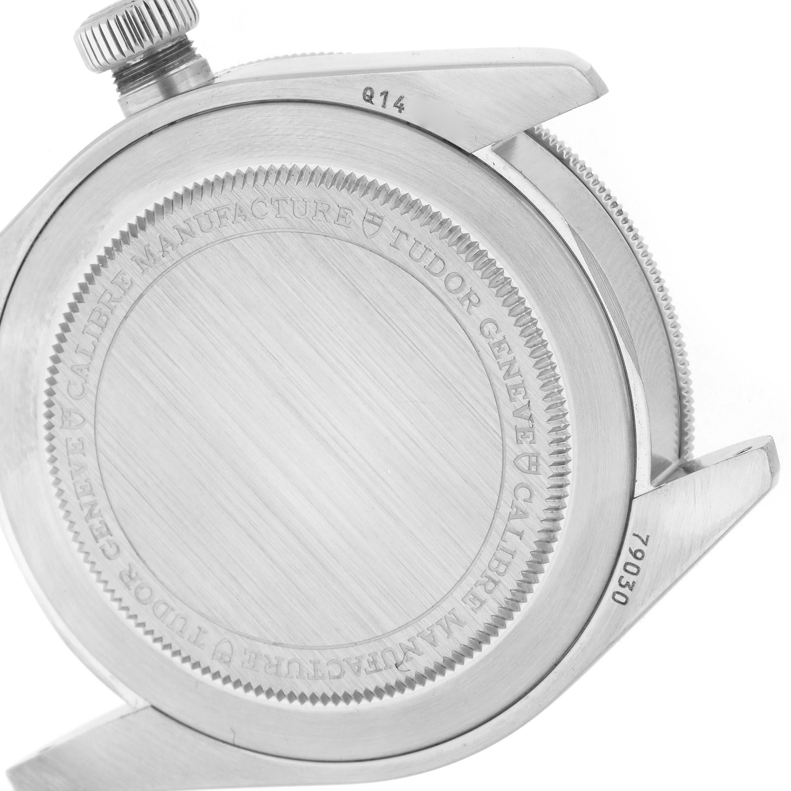 The image shows the back casing and crown of a Tudor Heritage Black Bay 79030B Men's Stainless Steel Blue Dial 79030B Men's Stainless Steel Blue Dial watch, highlighting the engraved details.