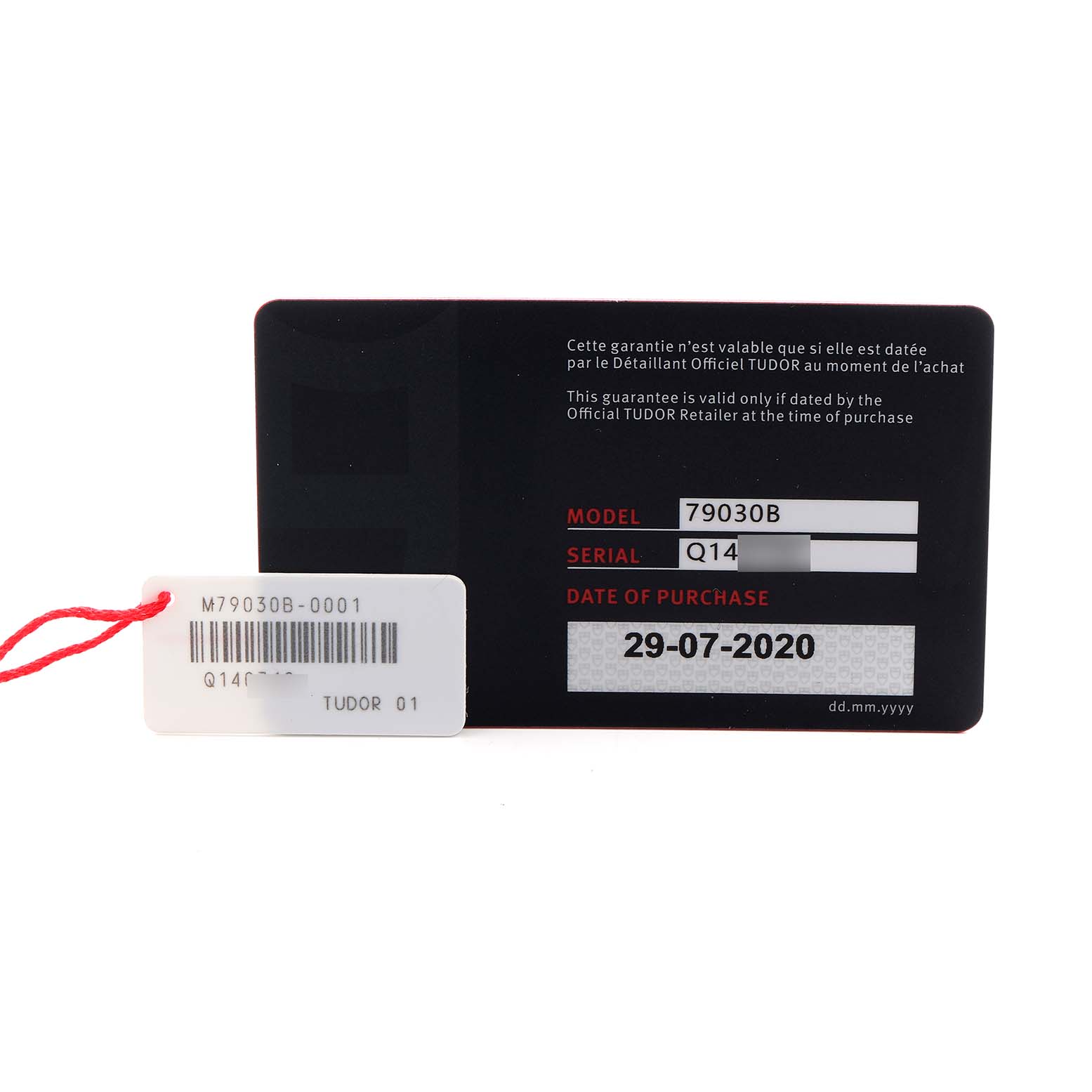 The image shows a warranty card and tag for the Tudor Heritage Black Bay 79030B Men's Stainless Steel Blue Dial 79030B Men's Stainless Steel Blue Dial model.