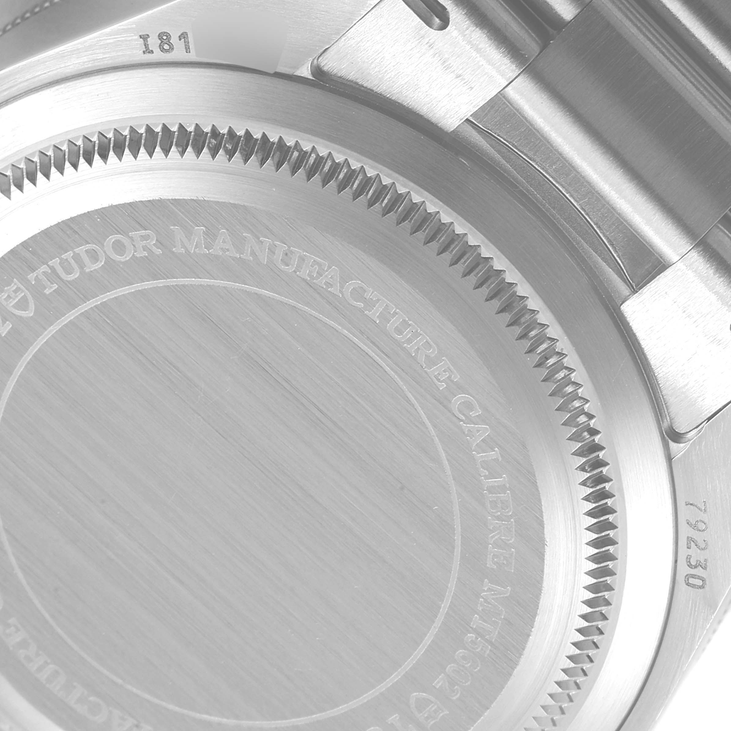 The image shows the back case of the Tudor Heritage Black Bay 79230 Men's Stainless Steel Black Dial 79230 Men's Stainless Steel Black Dial watch, including part of the bracelet and engraved details.