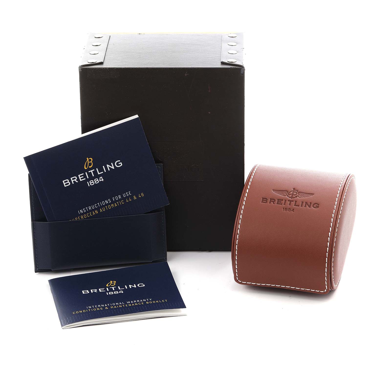 The image shows a Breitling Chronomat IB0110 Men's Steel and Gold (two tone) Black Dial IB0110 Men's Steel and Gold (two tone) Black Dial box, manual, and a leather case from a slightly overhead angle.