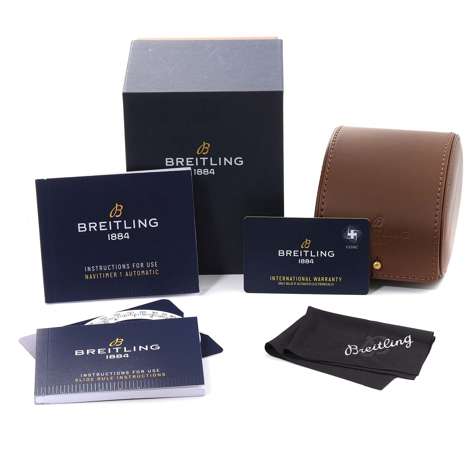 The image shows accessories for a Breitling Navitimer A17326 Men's Stainless Steel Silver Dial A17326 Men's Stainless Steel Silver Dial, including a box, manual, warranty card, leather case, and cleaning cloth.