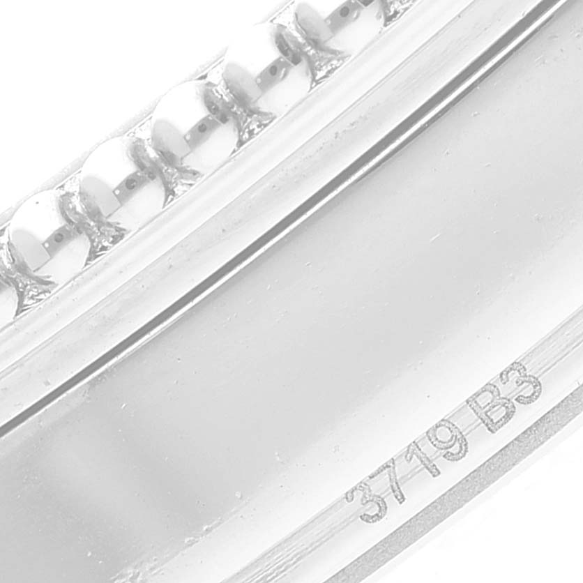 The image shows a close-up of the bezel and side of a Breitling Navitimer A17326 Men's Stainless Steel Silver Dial A17326 Men's Stainless Steel Silver Dial watch with part of a serial number.