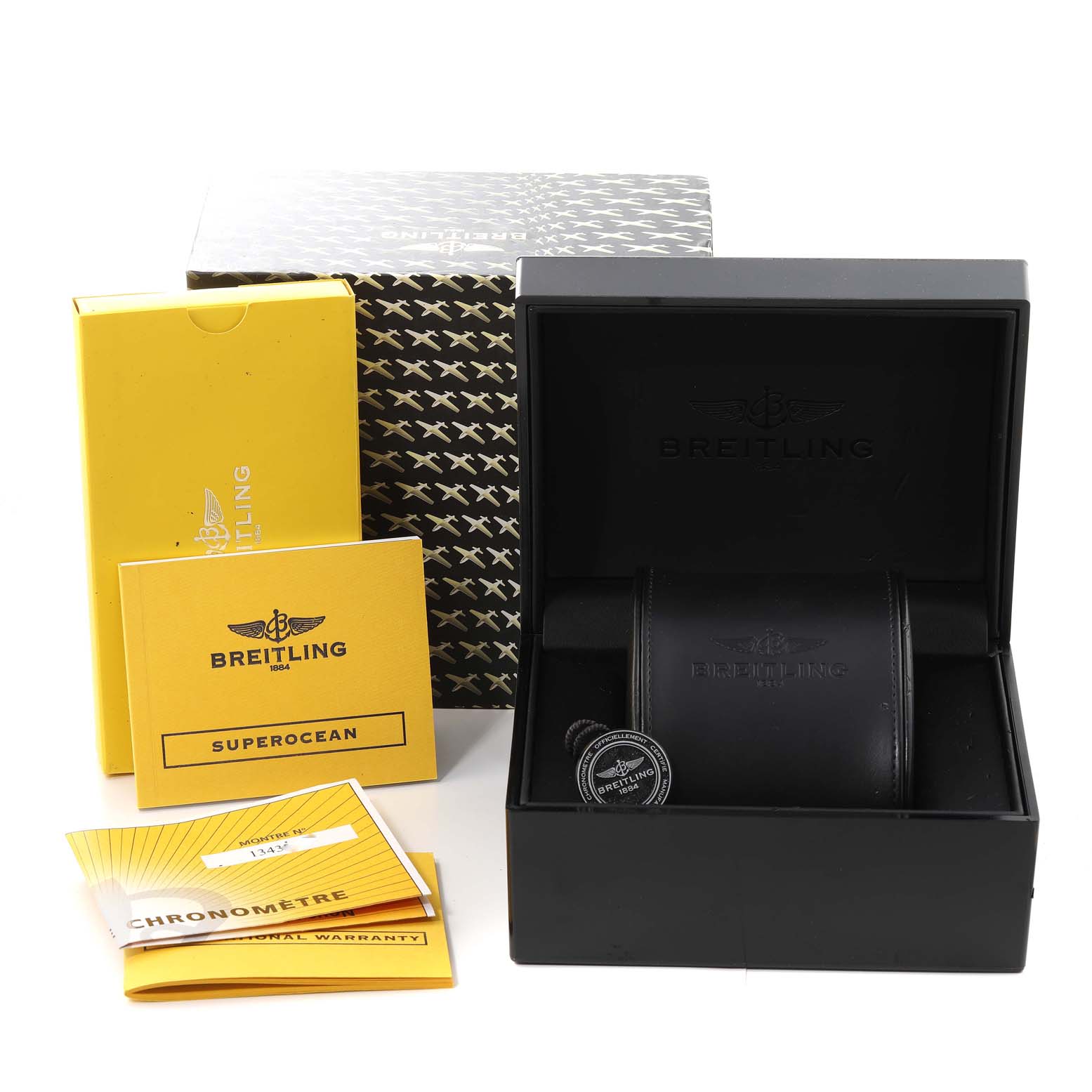 The image shows the packaging and accessories for a Breitling Superocean A17364 Men's Stainless Steel Black Dial A17364 Men's Stainless Steel Black Dial watch, including the box, warranty booklet, and instruction manual.