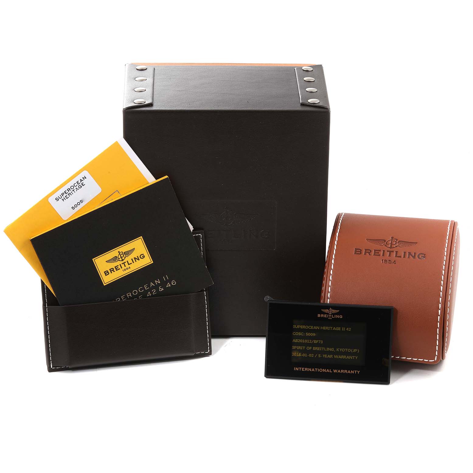 The image shows the packaging, manuals, and warranty card for a Breitling Superocean AB2010 Men's Stainless Steel Black Dial AB2010 Men's Stainless Steel Black Dial model watch.