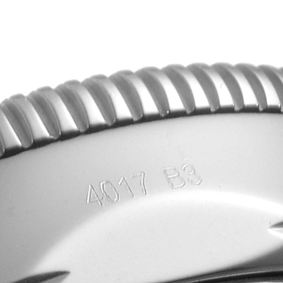 This image shows a close-up of the bezel and part of the casing of a Breitling Superocean AB2010 Men's Stainless Steel Black Dial AB2010 Men's Stainless Steel Black Dial watch, displaying some engraved numbers.