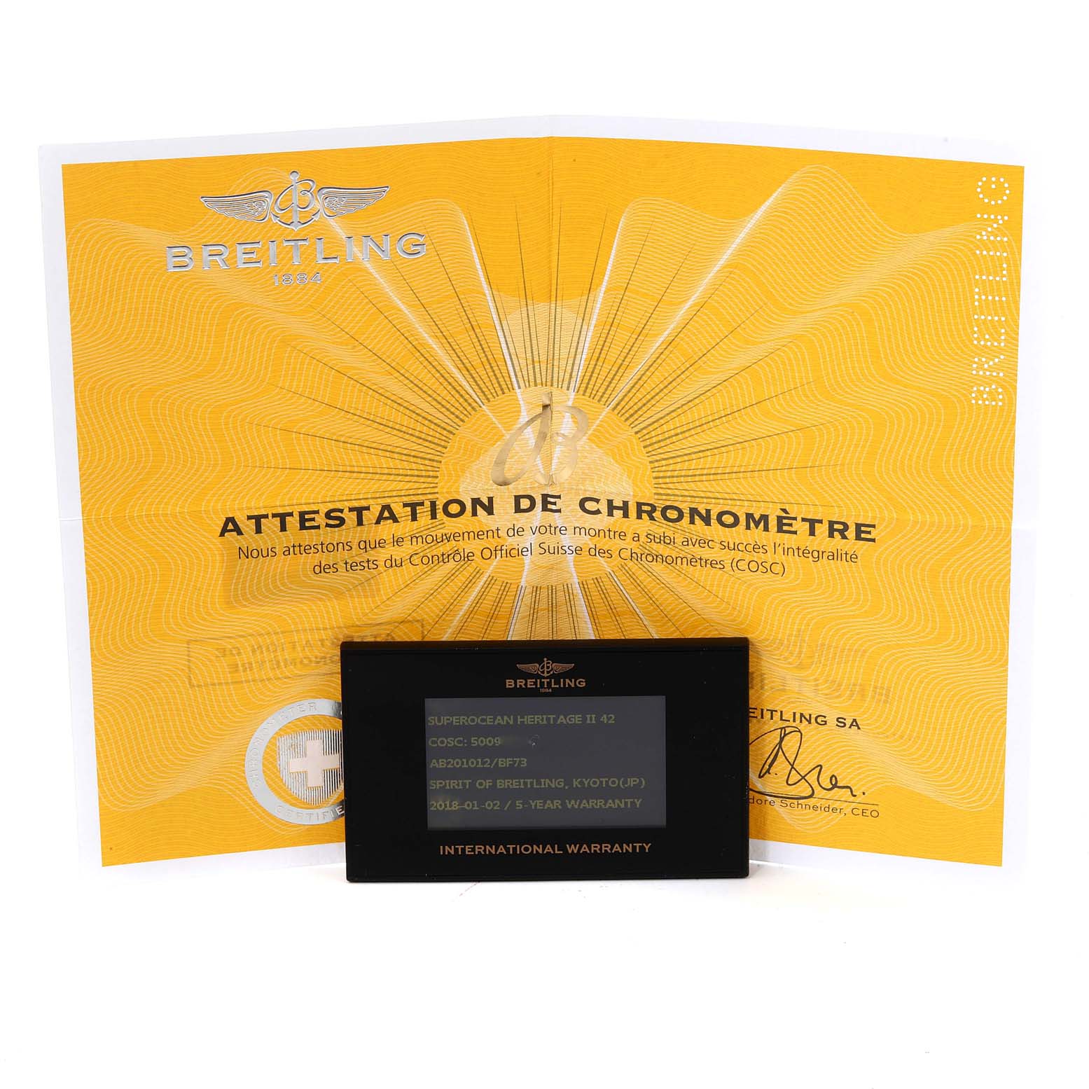 The image shows an angle displaying the Breitling Superocean AB2010 Men's Stainless Steel Black Dial AB2010 Men's Stainless Steel Black Dial model's chronometer certificate and international warranty card.