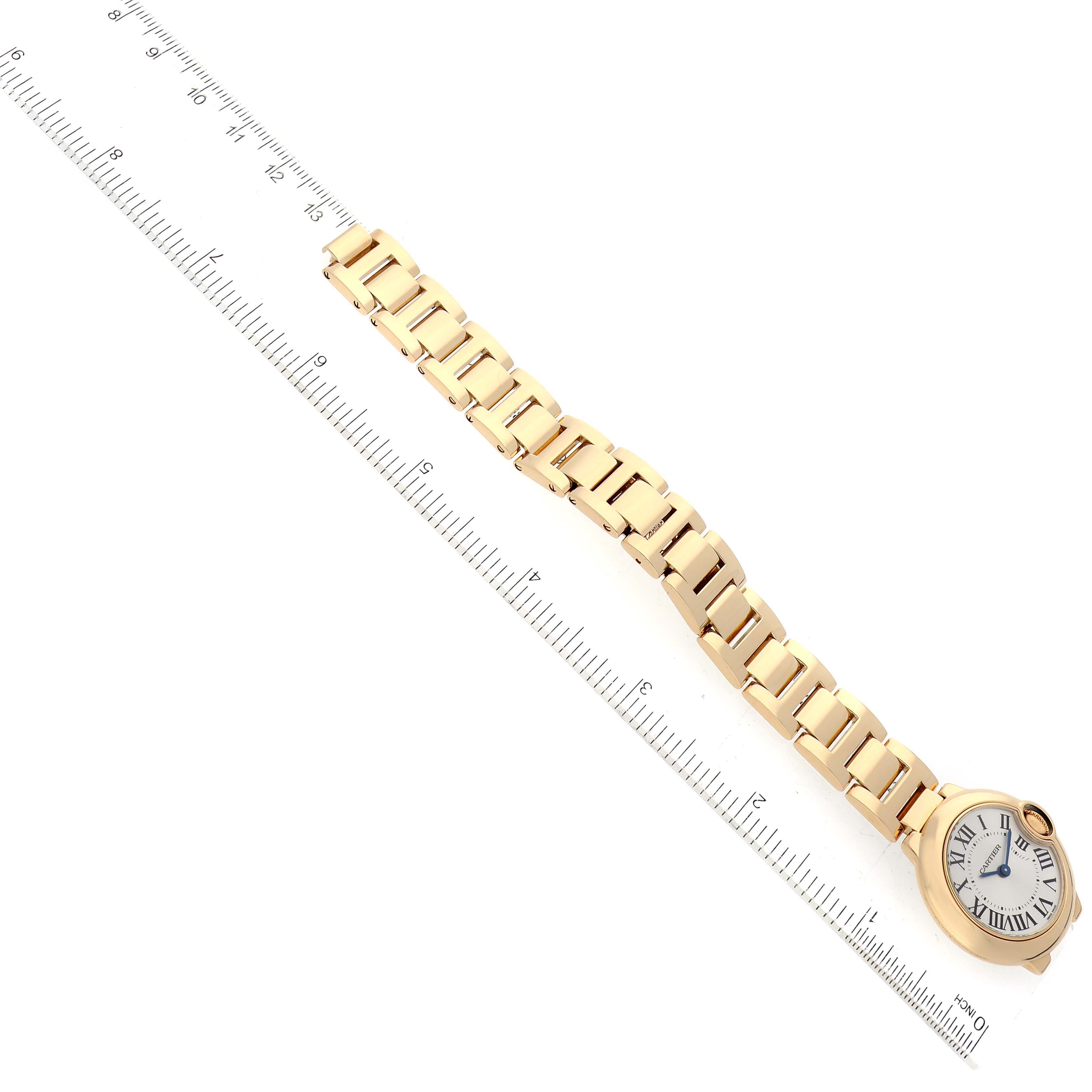 The Ballon Bleu by Cartier is shown from a top-down angle with its full watch face and entire bracelet visible next to a ruler.