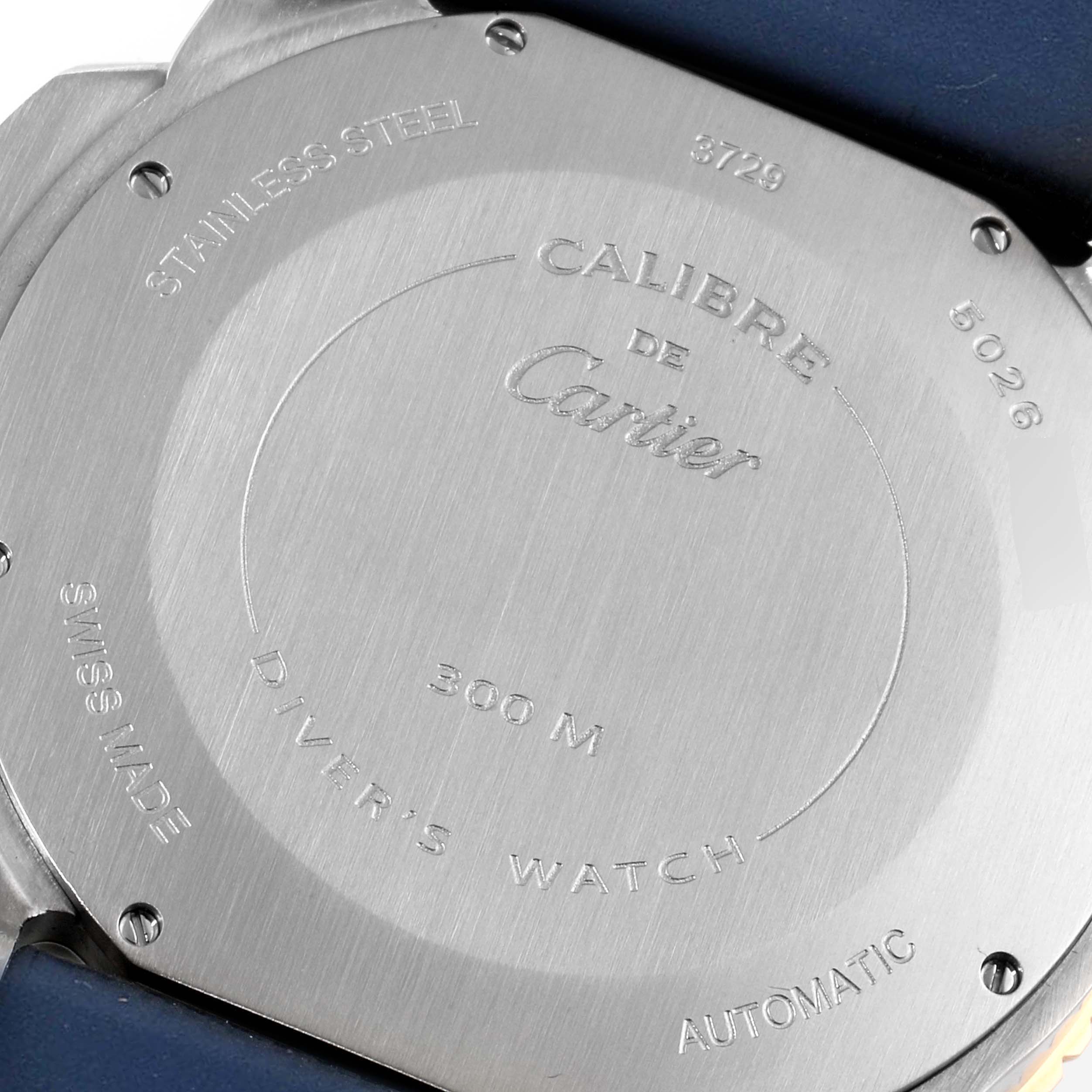 The image shows the back case of a Calibre de Cartier watch by Cartier, highlighting its engravings and stainless steel material.