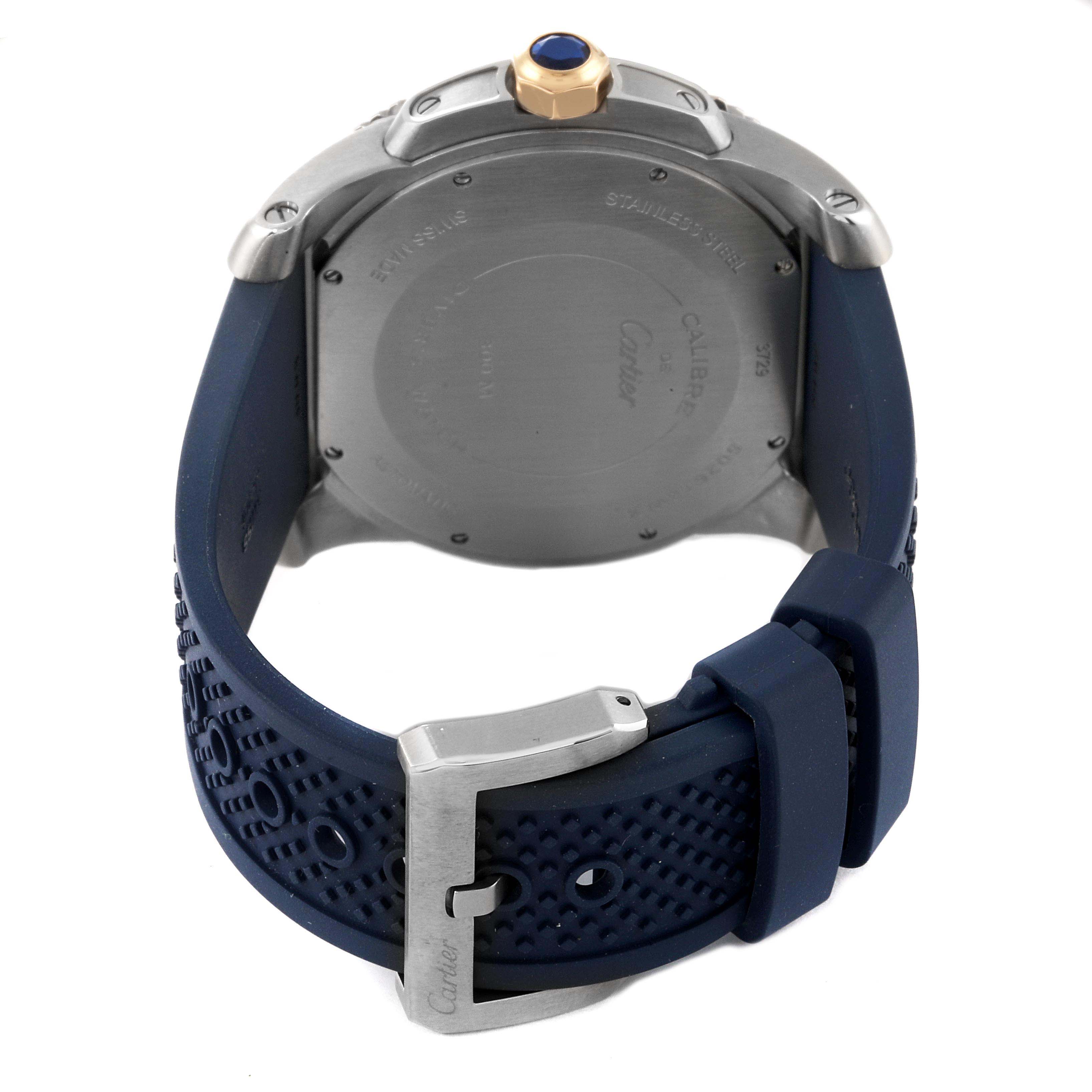 The image shows the back case, crown, and blue strap of the Calibre de Cartier watch by Cartier from a rear angle.
