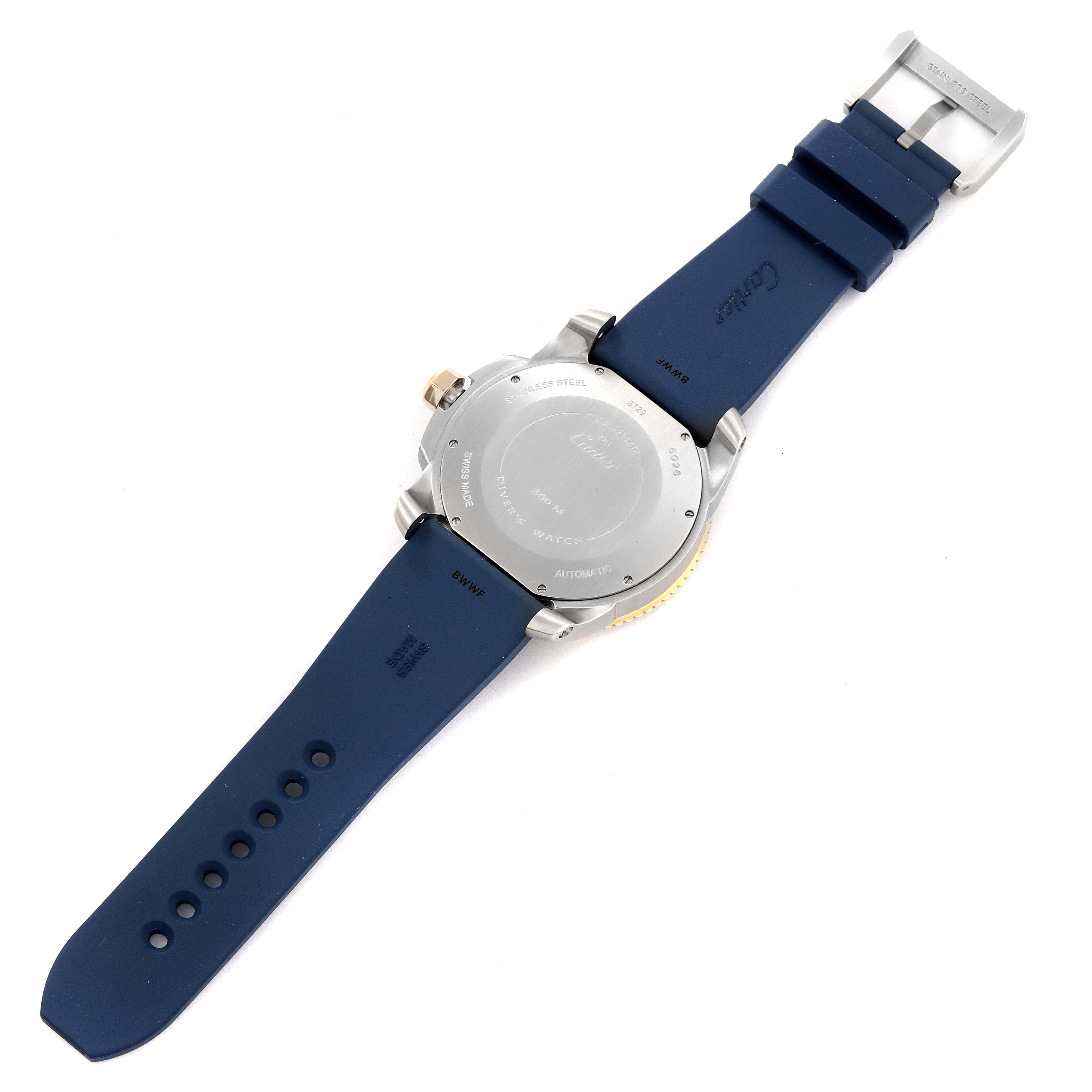 The image shows the back of a Calibre de Cartier watch by Cartier, revealing the case back, crown, and blue strap.