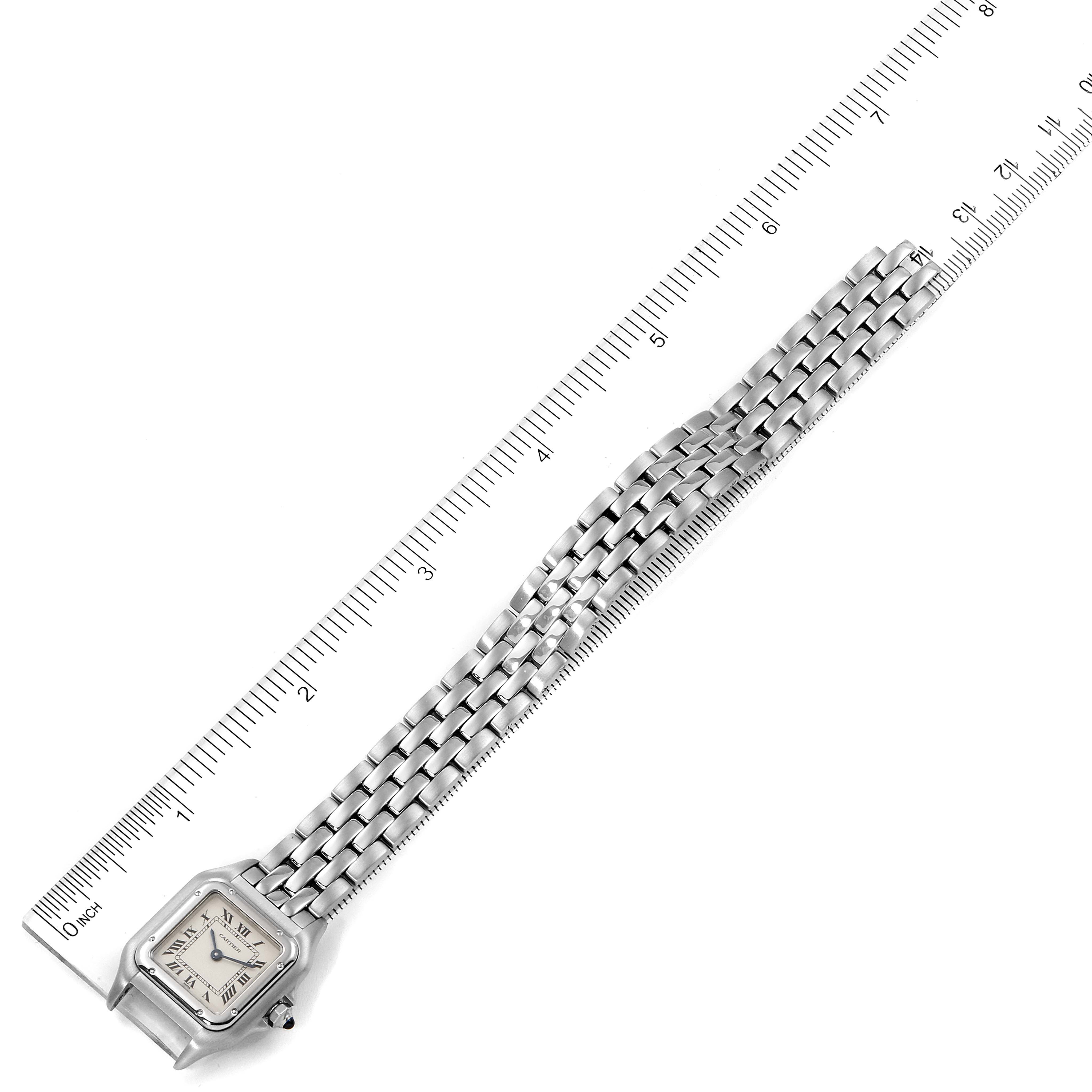 The image shows an overhead view of a Cartier Panthere W25033P5 Women
s Stainless Steel Silver Dial W25033P5 Women
s Stainless Steel Silver Dial watch with its full bracelet laid out alongside a ruler for scale.