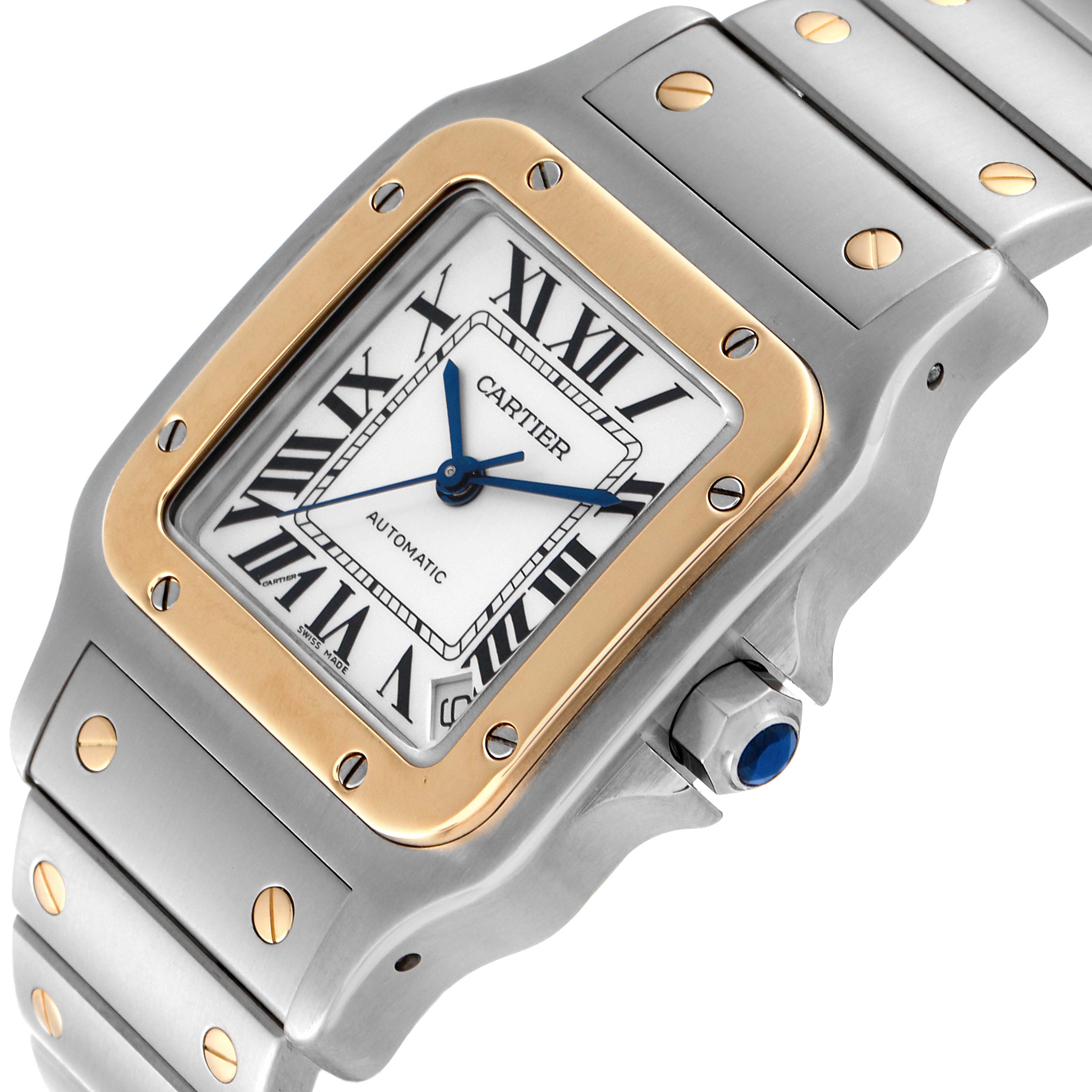 The image shows a close-up of the Santos model by Cartier, highlighting the case, bezel, dial, and partial bracelet.