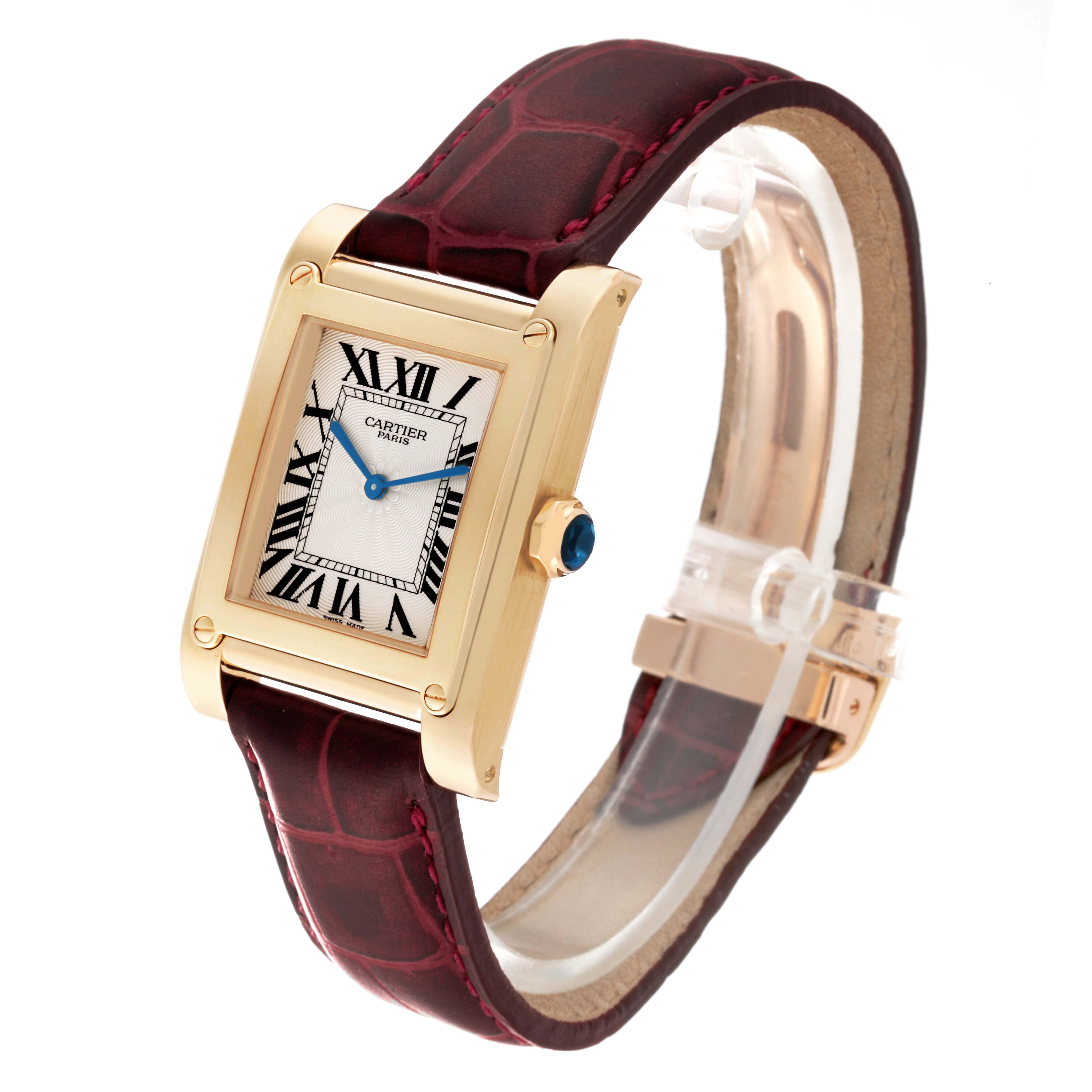 The Cartier Tank A Vis W1529451 Men's Yellow Gold Silver Dial W1529451 Men's Yellow Gold Silver Dial watch is shown at a three-quarter angle, highlighting its rectangular face, Roman numerals, and leather strap.