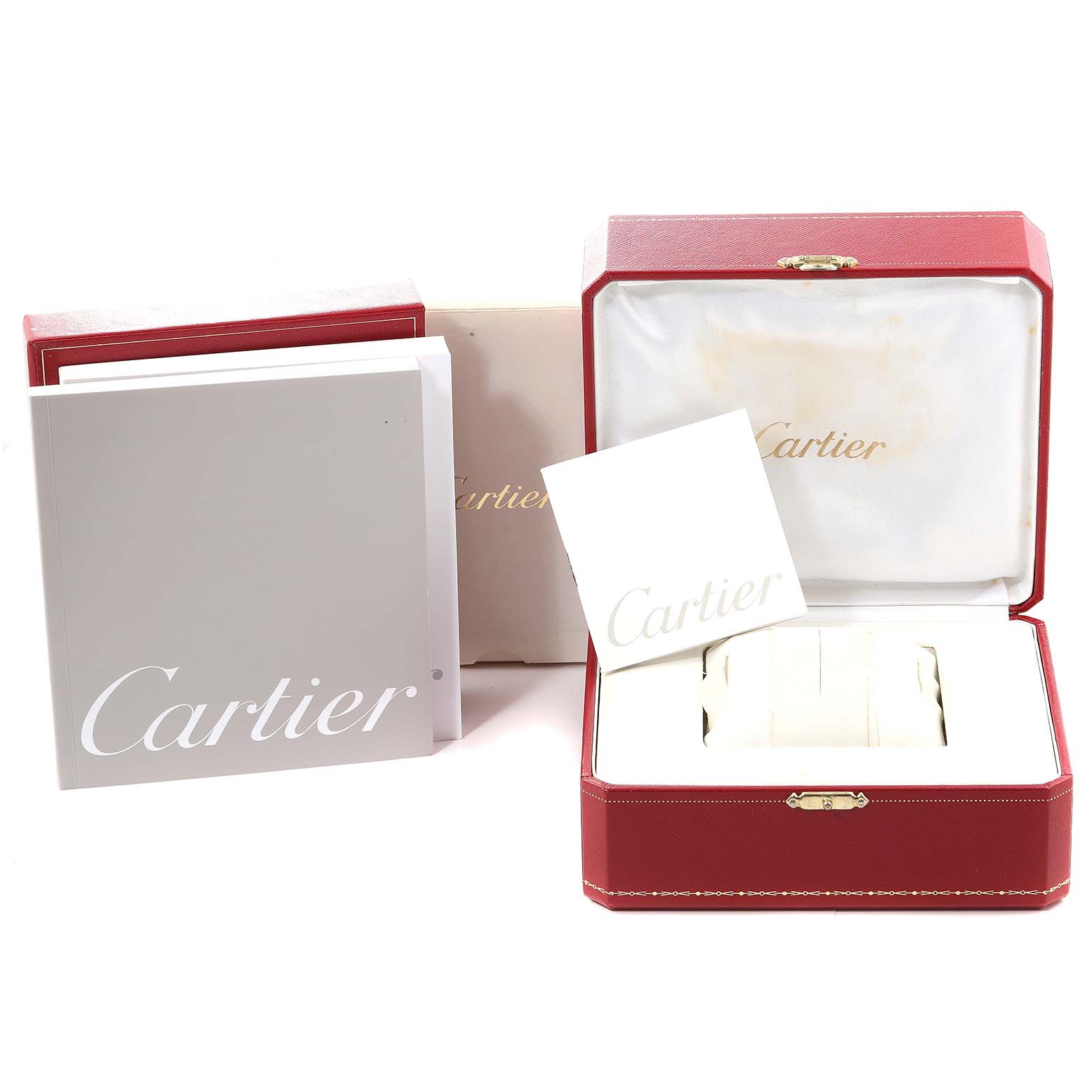 The image shows the packaging and documentation of the Tank Française model by Cartier, including boxes and booklets.