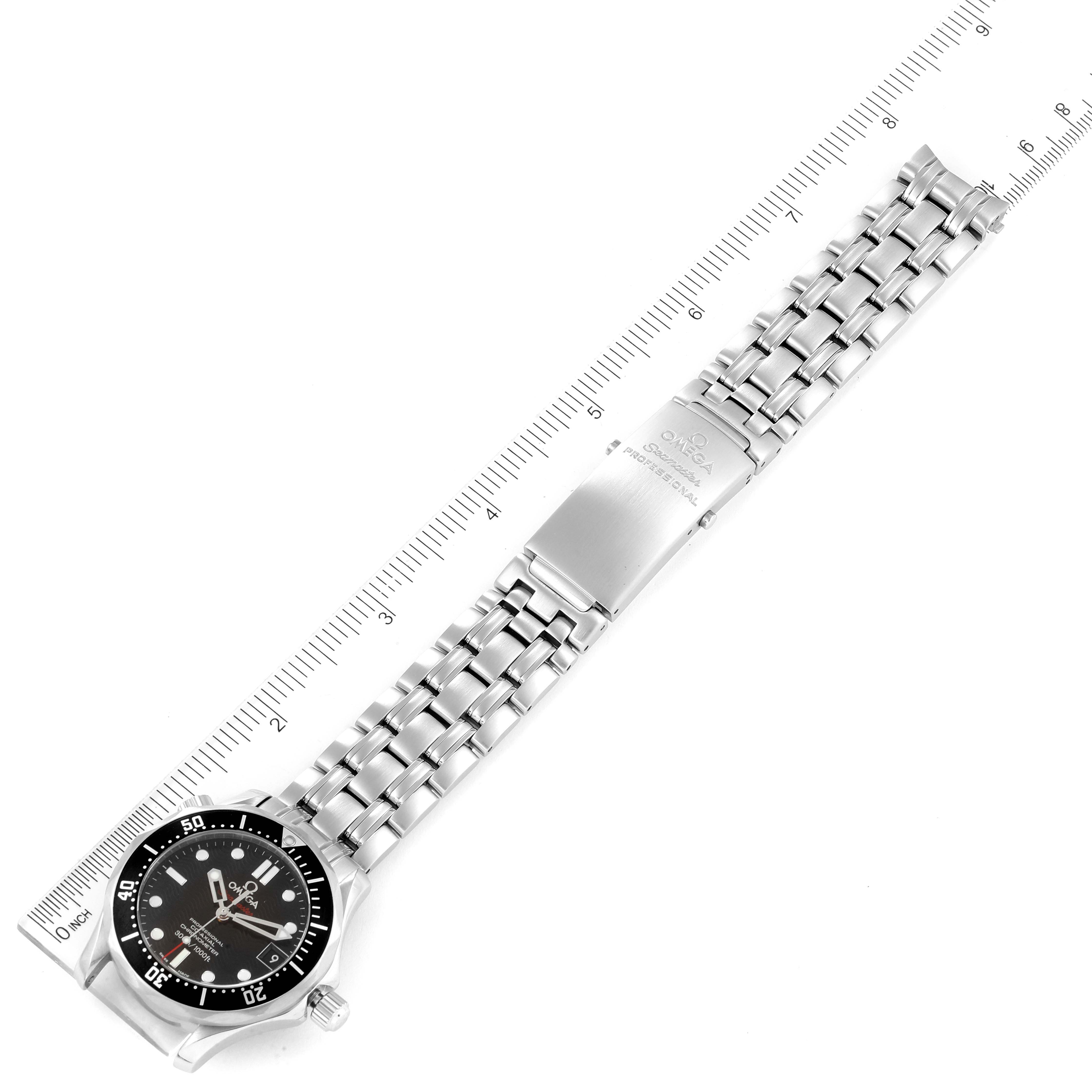 The image shows an Omega Seamaster 212.30.36.20.01.001 Men's Stainless Steel Black Dial 212.30.36.20.01.001 Men's Stainless Steel Black Dial watch laying flat with its bracelet spread out next to a ruler for scale.