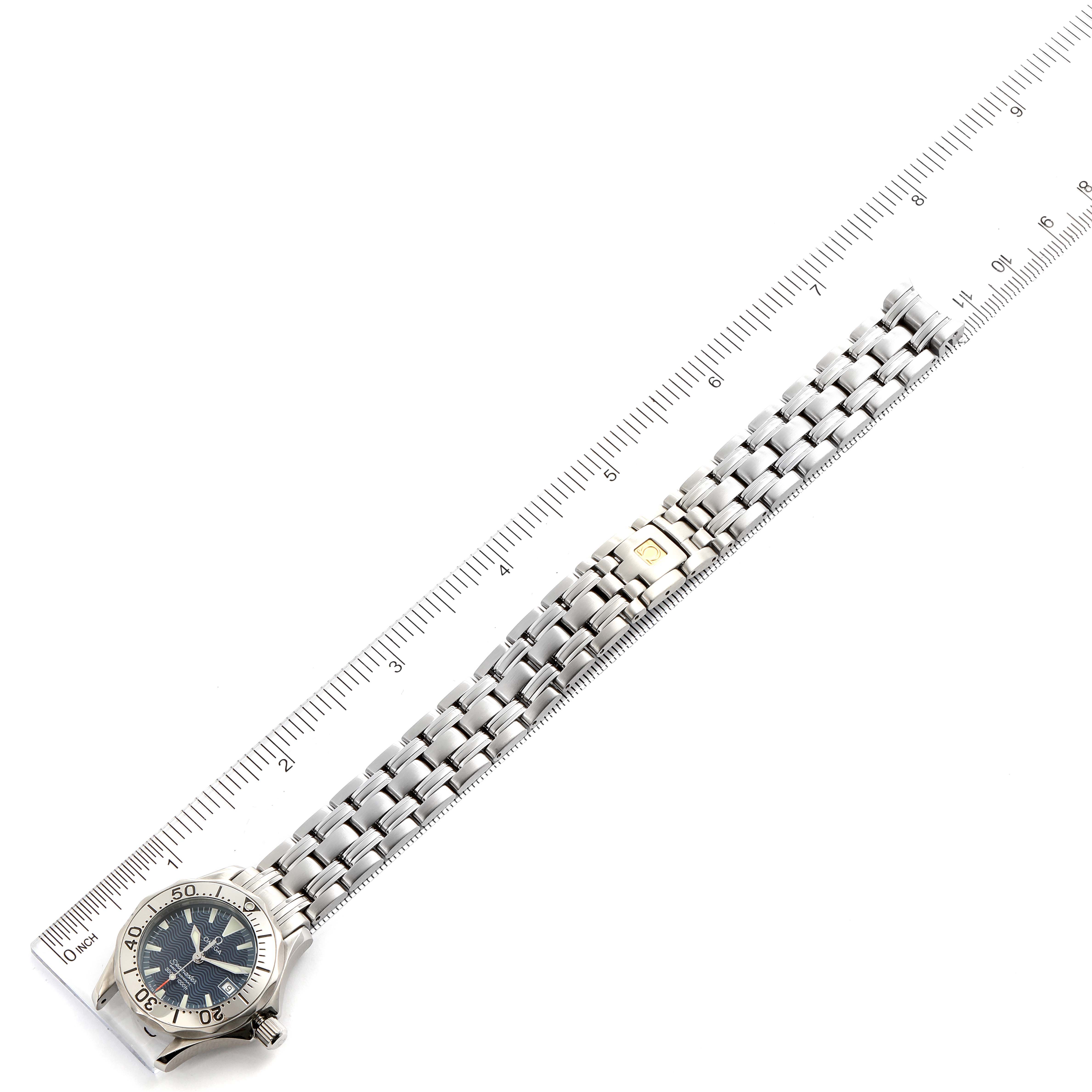 The Omega 2285.80.00 Women's Stainless Steel Blue Dial 2285.80.00 Women's Stainless Steel Blue Dial Seamaster Diver 300M Quartz 28mm Steel Ladies Watch 2285.80.00 is shown laid flat alongside a ruler for scale.