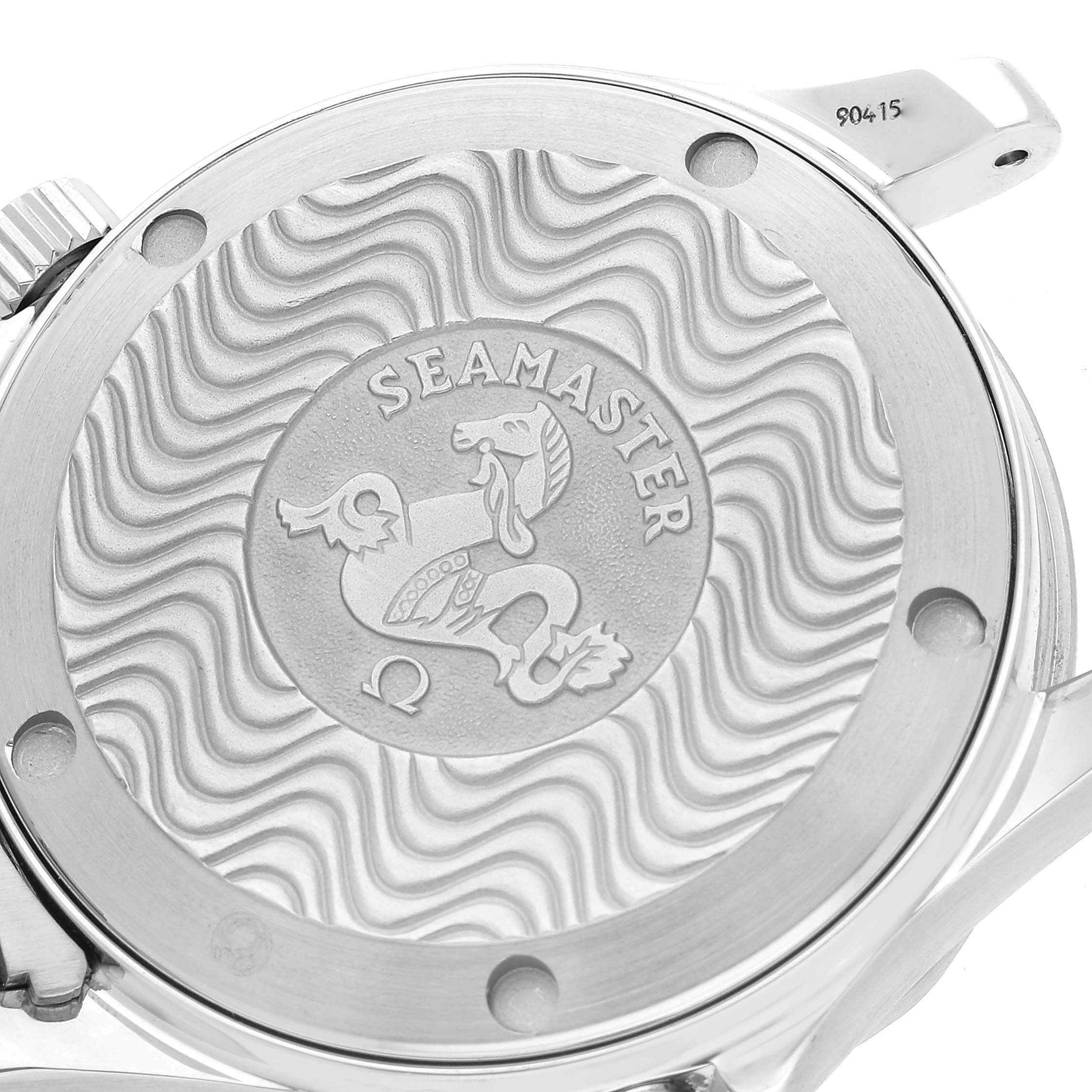 The image shows the back case of an Omega Seamaster 2263.80.00 Men
s Stainless Steel Blue Dial 2263.80.00 Men
s Stainless Steel Blue Dial watch, highlighting the engraved logo and wavy pattern.