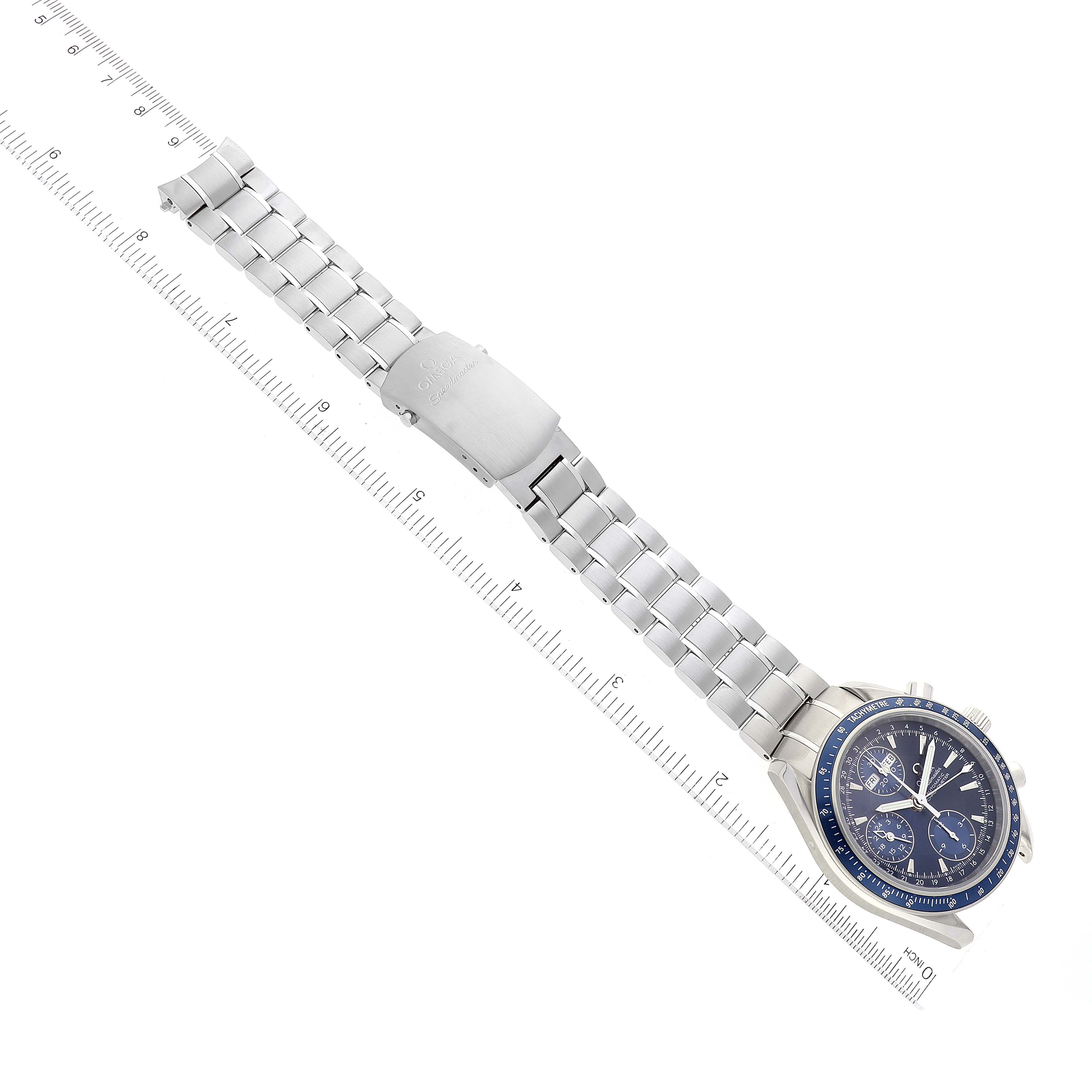 This image shows an Omega Speedmaster 3222.80.00 Men's Stainless Steel Blue Dial 3222.80.00 Men's Stainless Steel Blue Dial watch at an overhead angle, highlighting the bracelet, clasp, and face against a ruler.