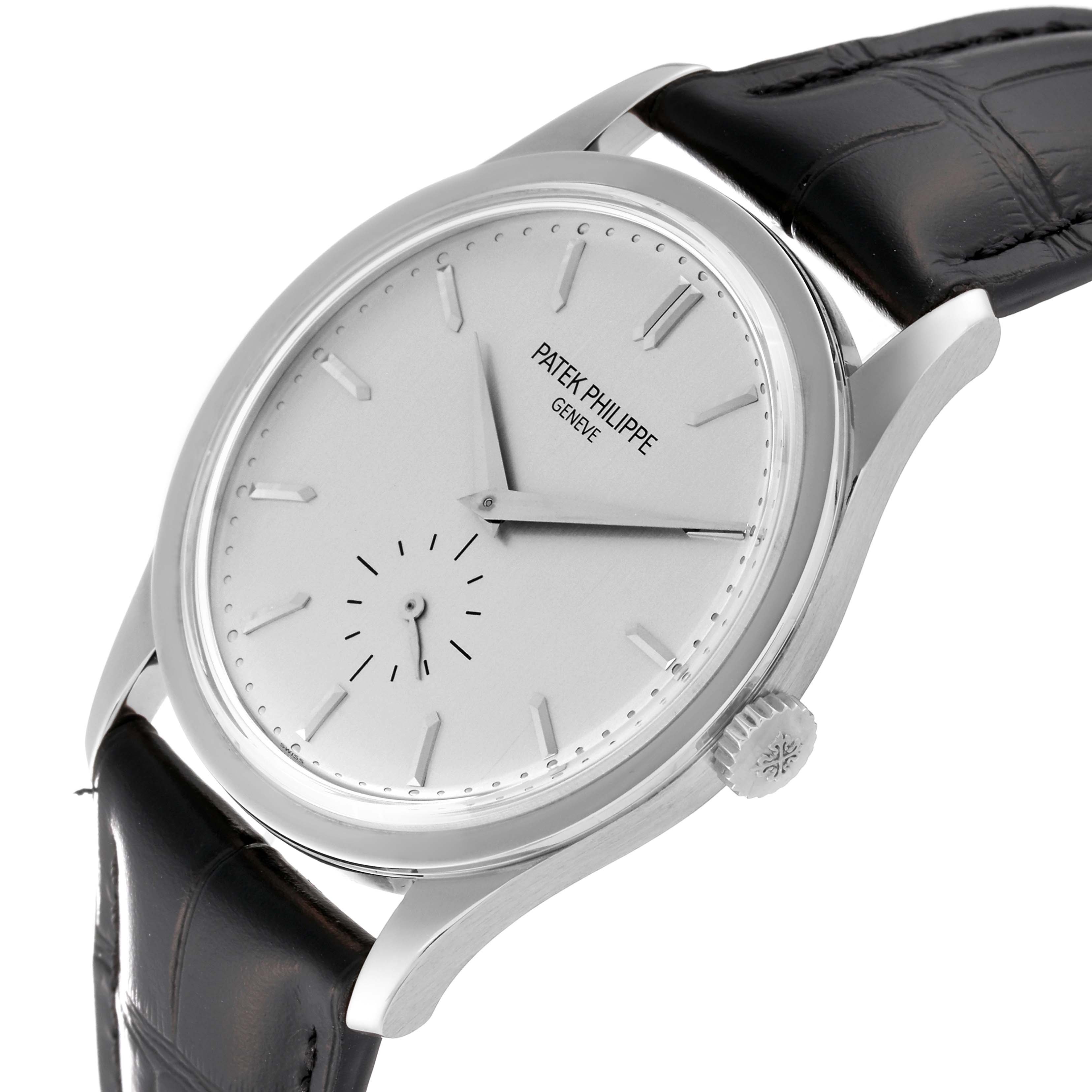 The image shows a Patek Philippe Calatrava 5196G Men
s White Gold Silver Dial 5196G Men
s White Gold Silver Dial watch at a slight angle, highlighting its face, bezel, crown, and black leather strap.